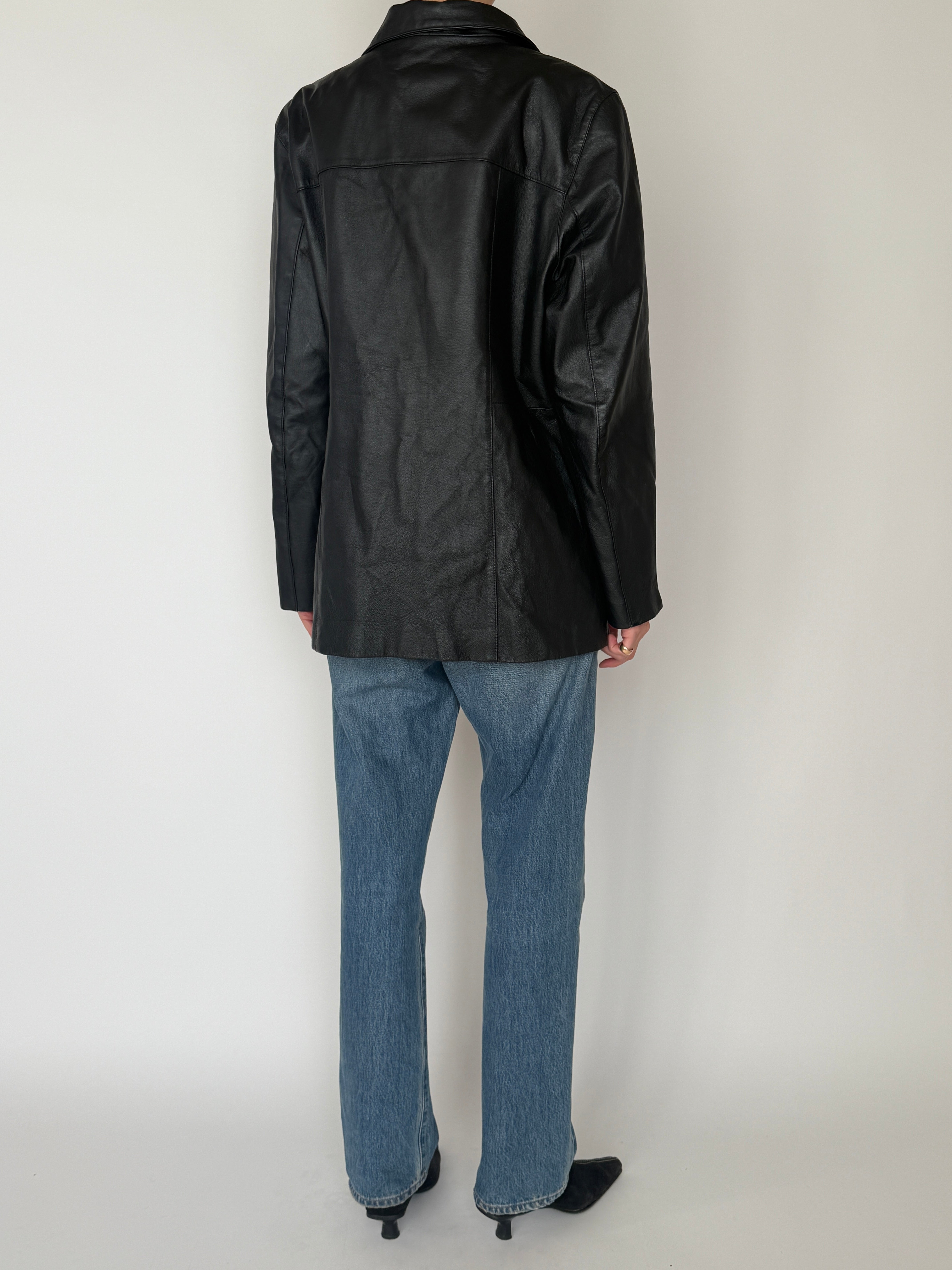 Vintage black leather jacket sleeve detail smooth leather texture
