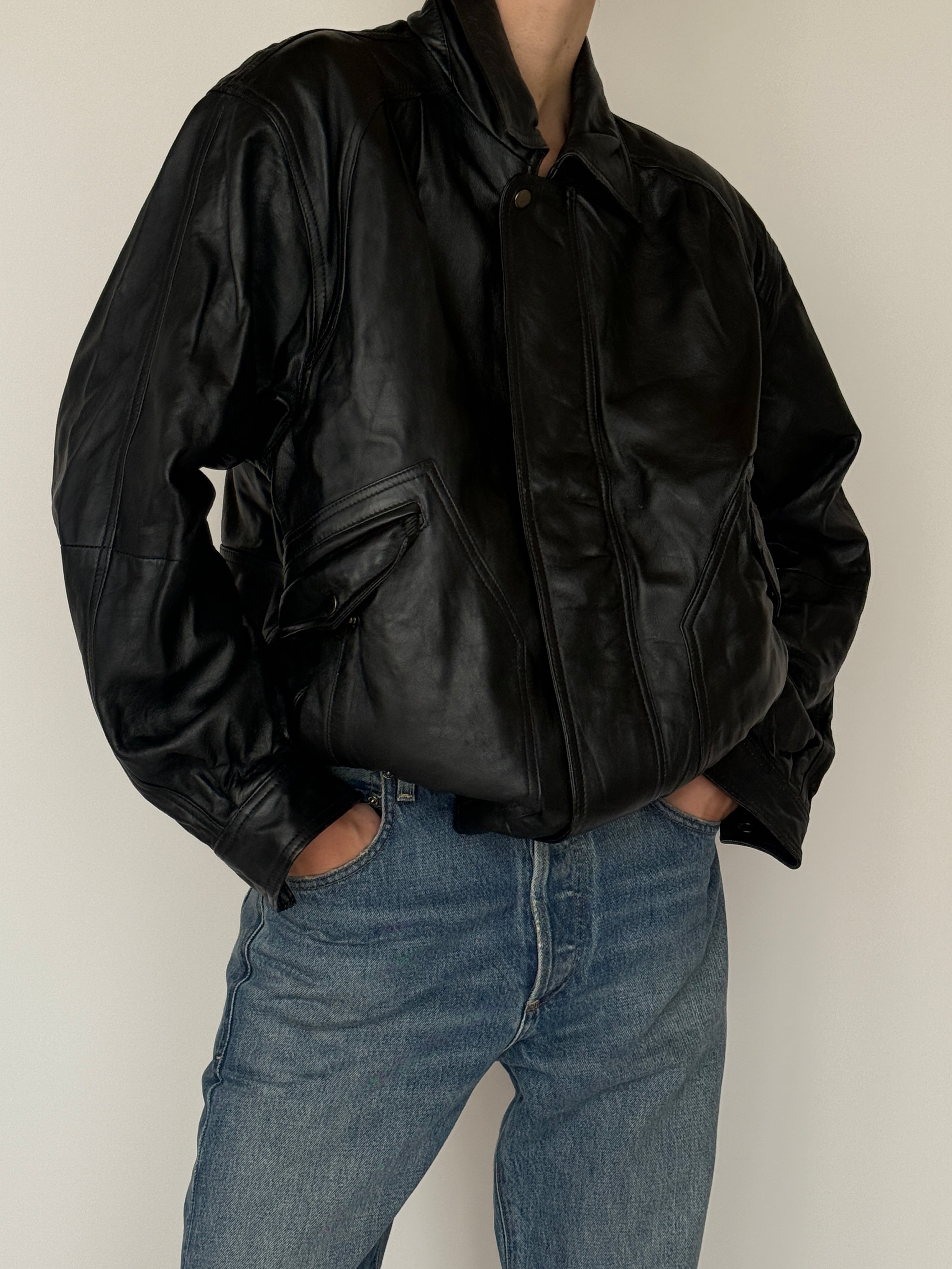 Vintage black leather bomber jacket pocket detail