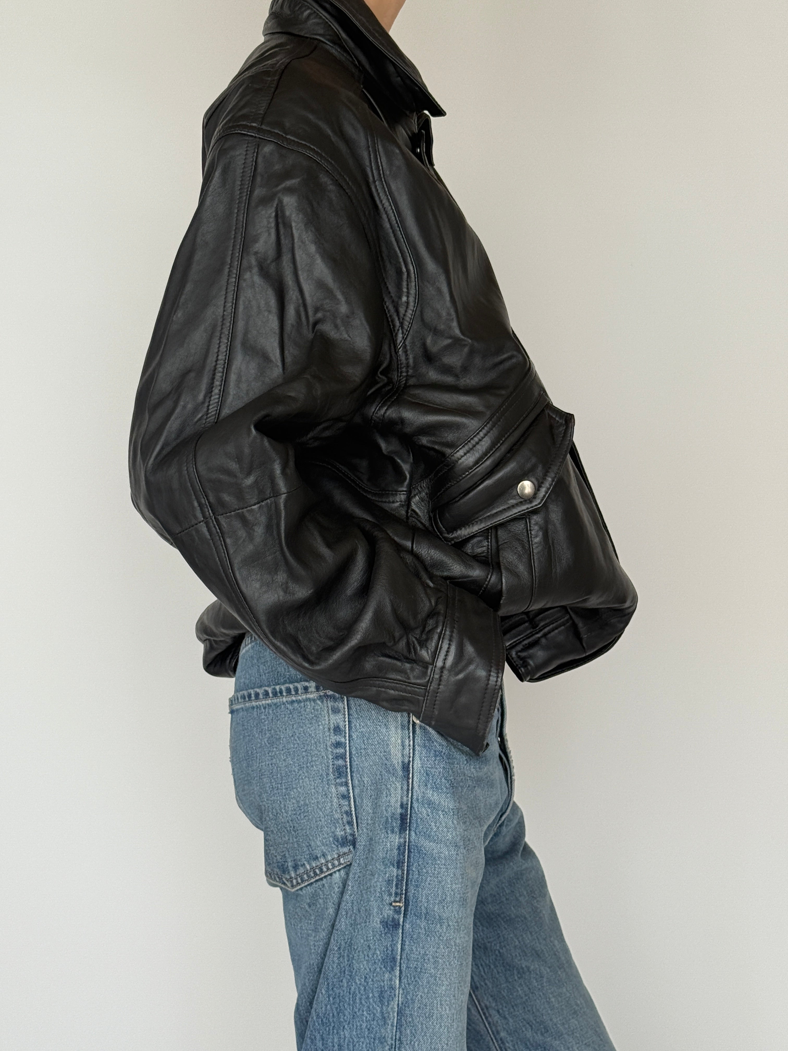 Vintage black leather bomber jacket side view