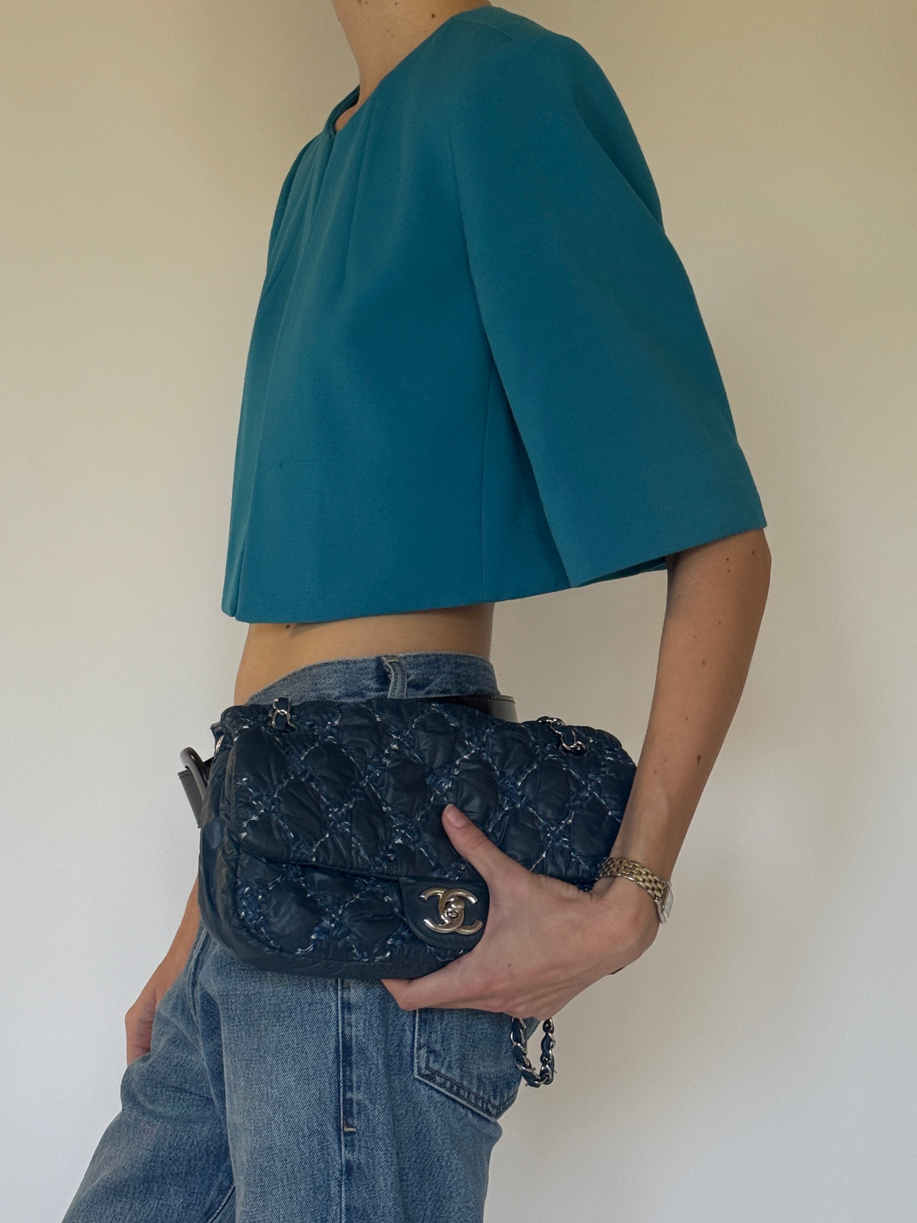 Vintage Calvin Klein teal cropped stretch jacket side view sculptural sleeve