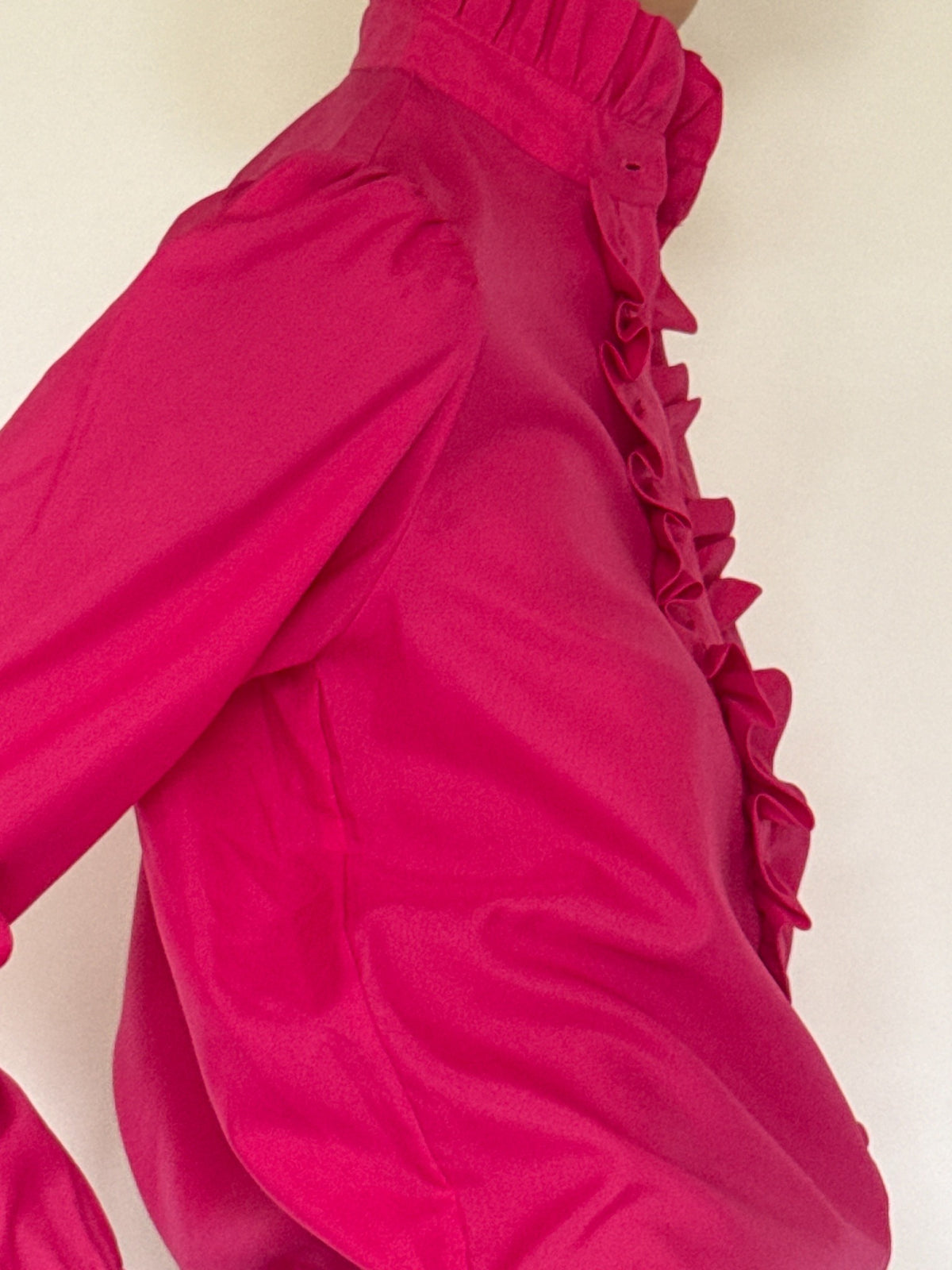 Close-up of fuchsia blouse shoulder and side silhouette