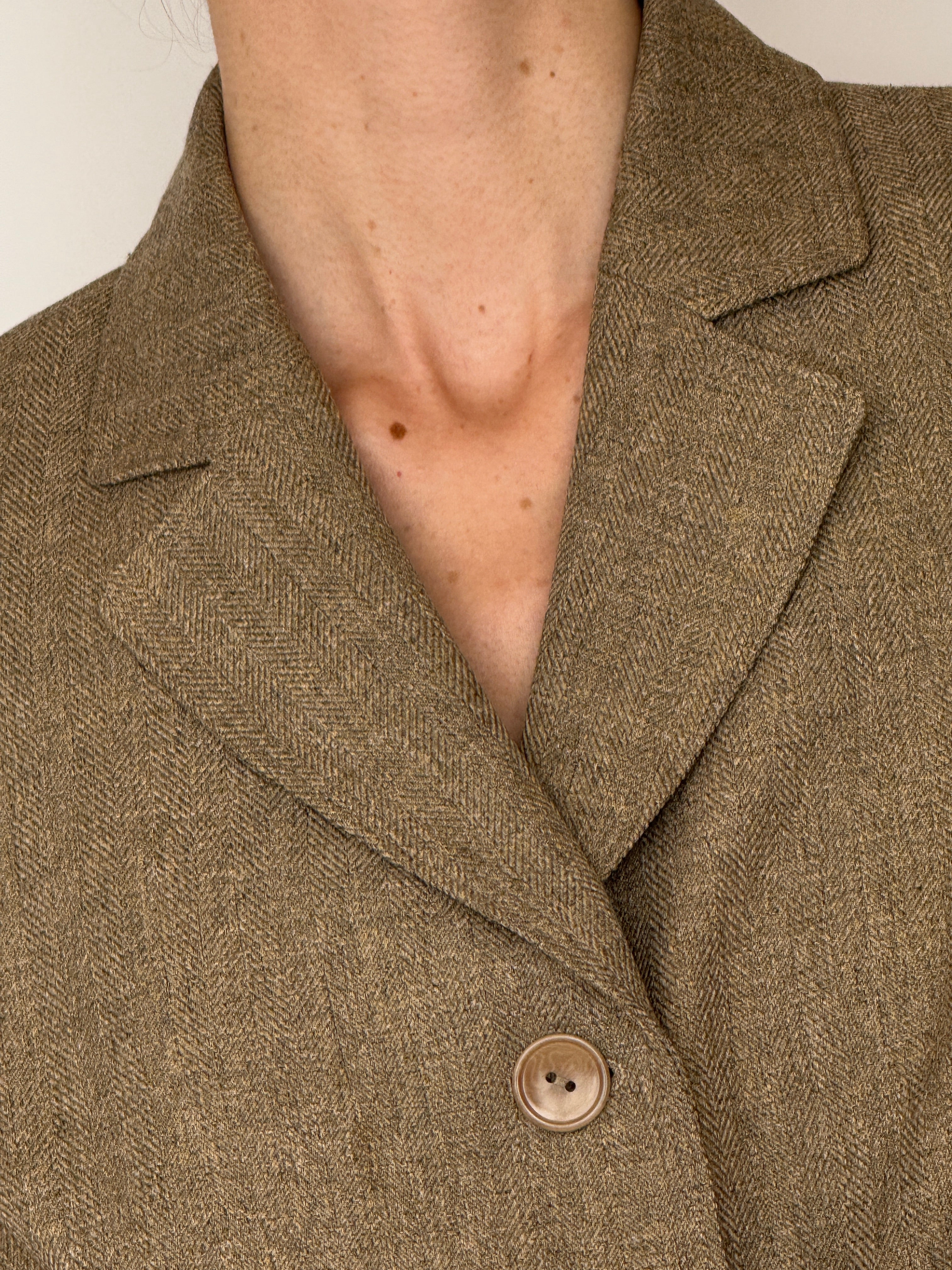 Vintage herringbone fabric close-up brown blazer