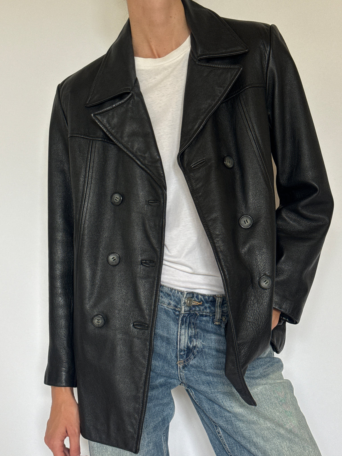 Vintage black leather blazer texture close-up