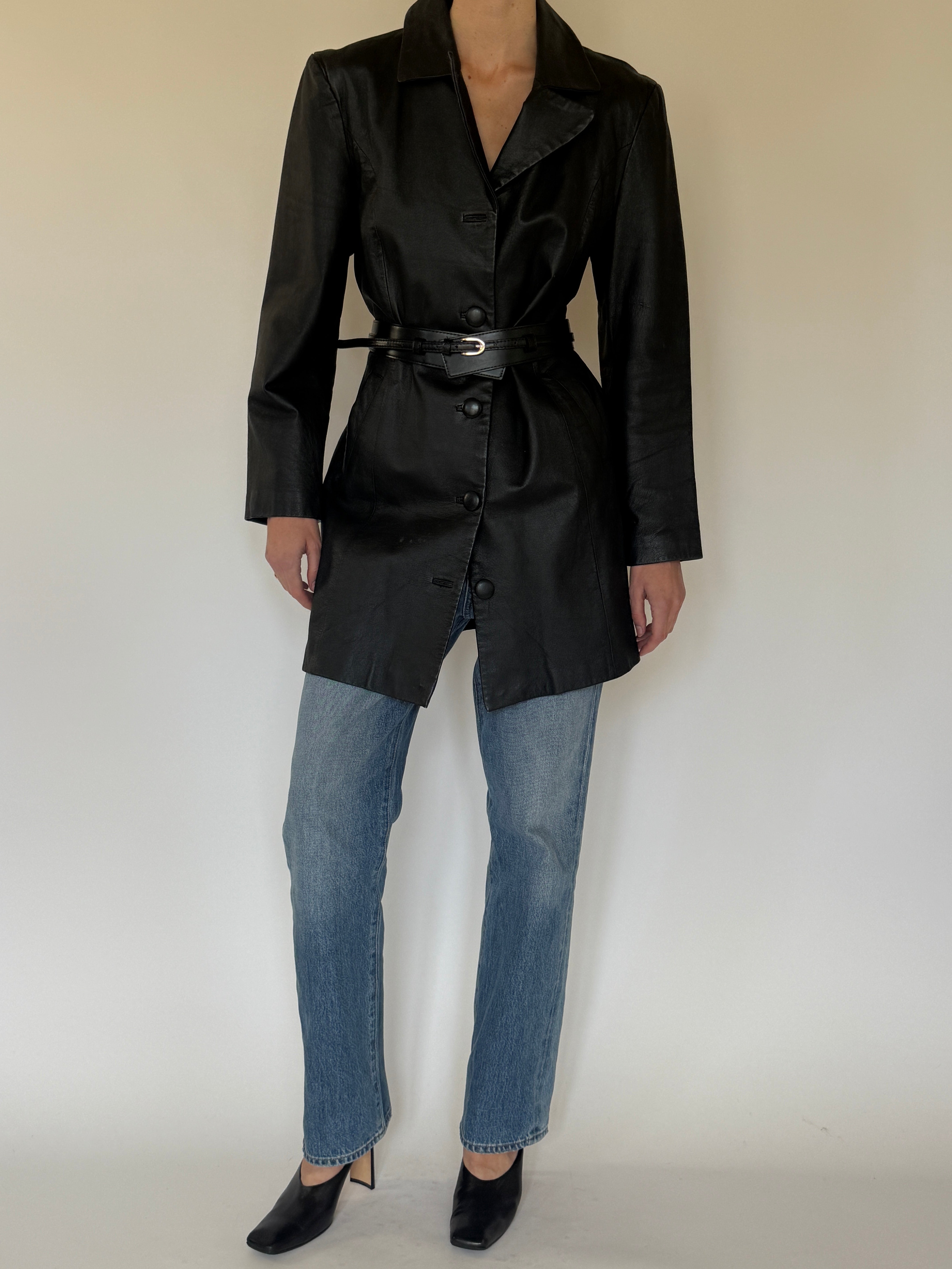 Vintage black leather coat front view with button closure