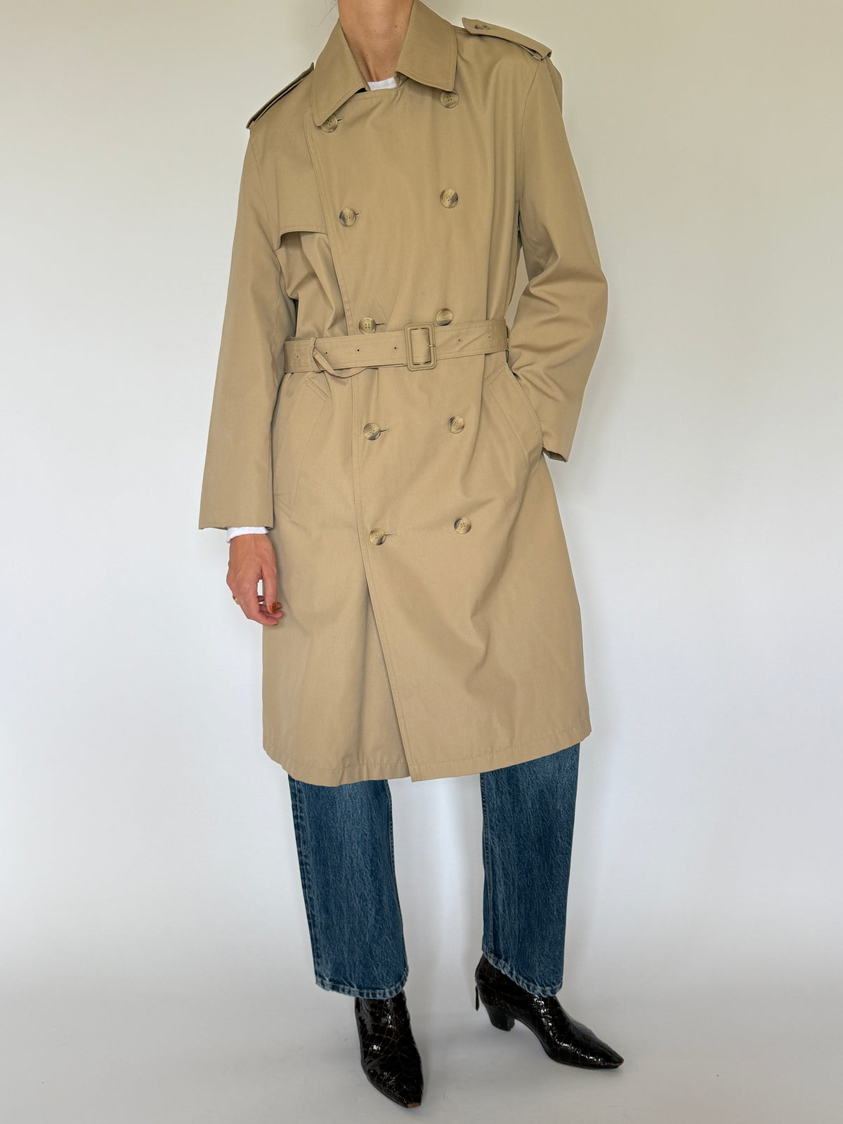 Vintage tan trench coat front view with double-breasted button closure and belted waist