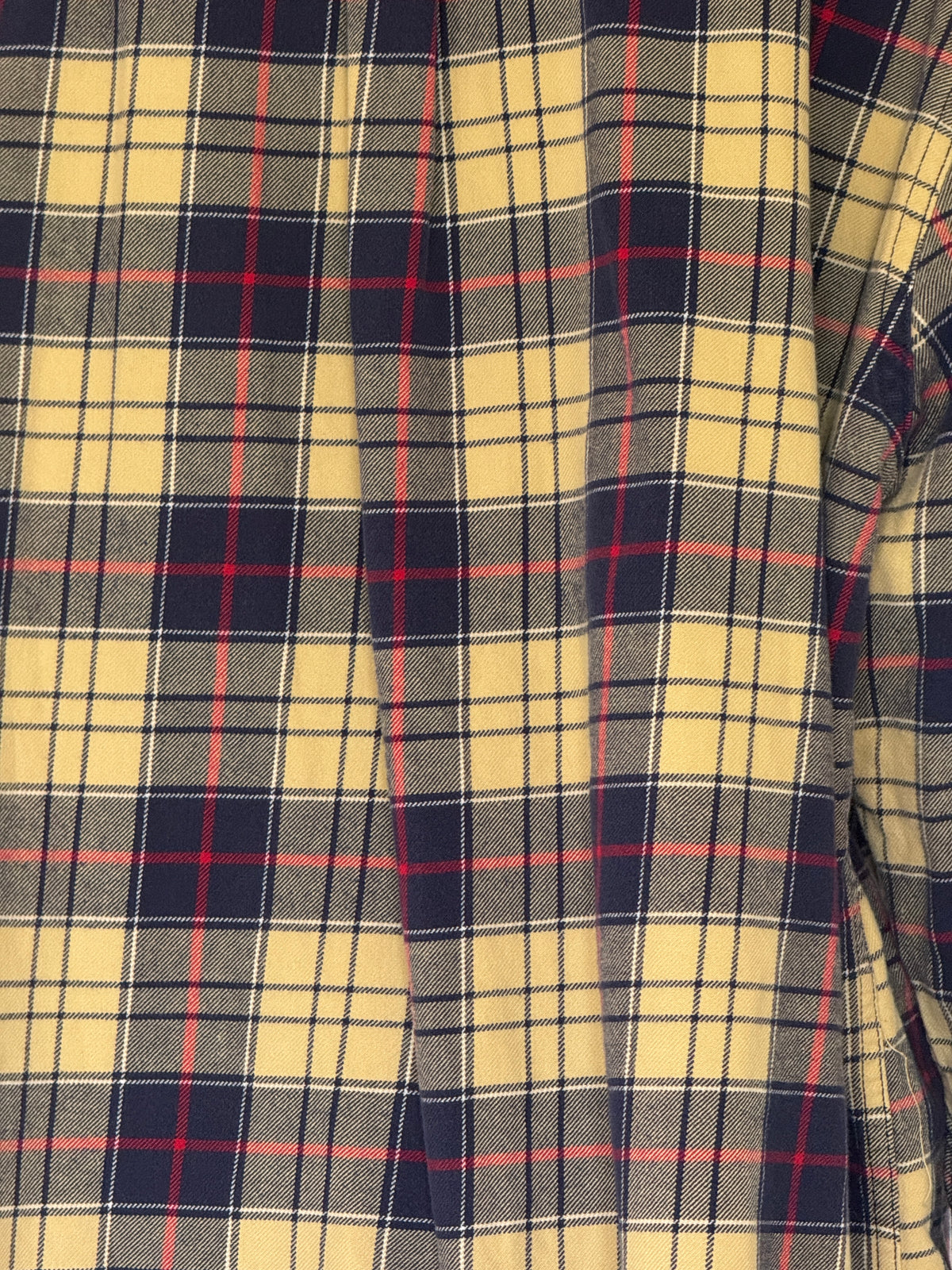 Vintage yellow plaid flannel shirt close-up showing woven plaid fabric