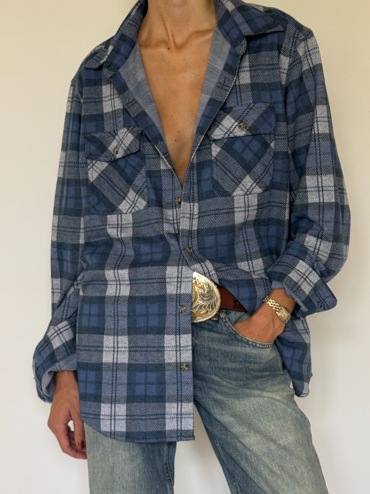 Vintage blue plaid shirt pocket and button detail