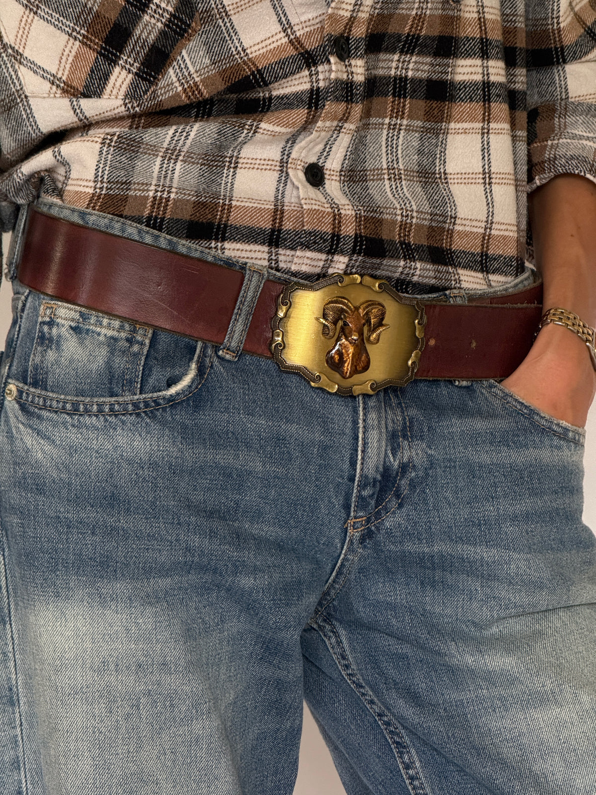 Vintage ram motif statement belt worn at waist