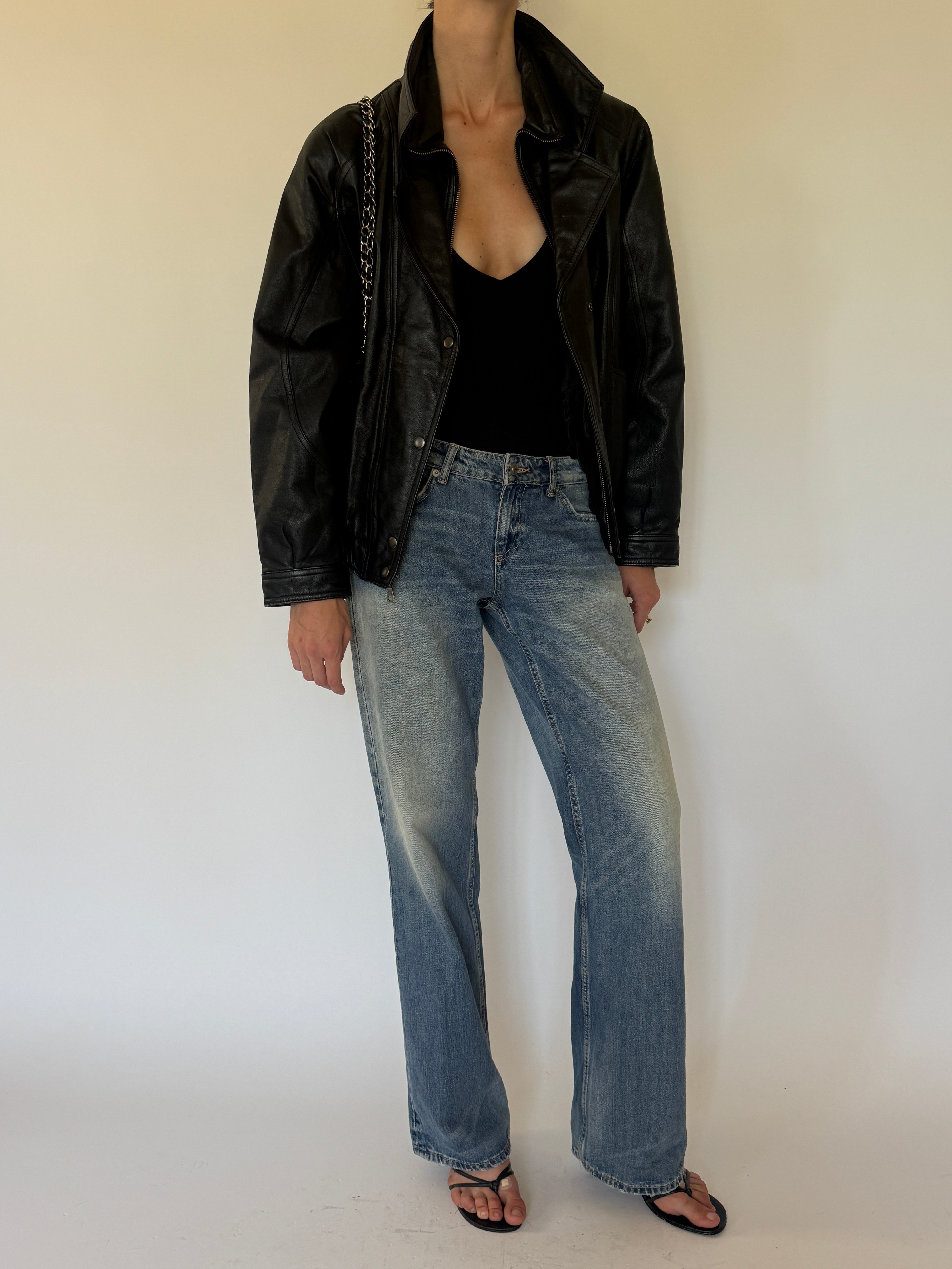 Vintage oversized black leather bomber jacket side view