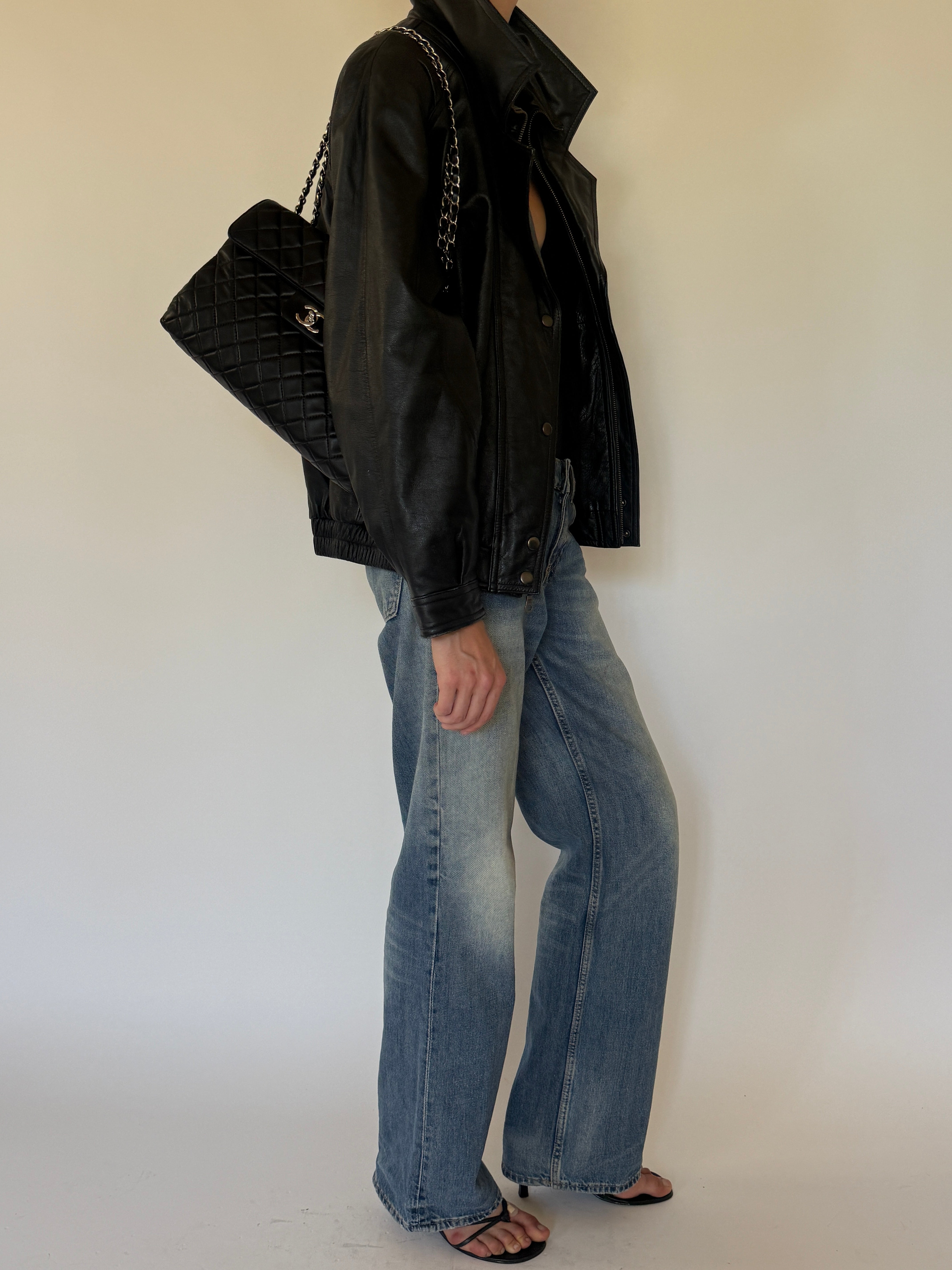 Vintage oversized black leather bomber jacket side view