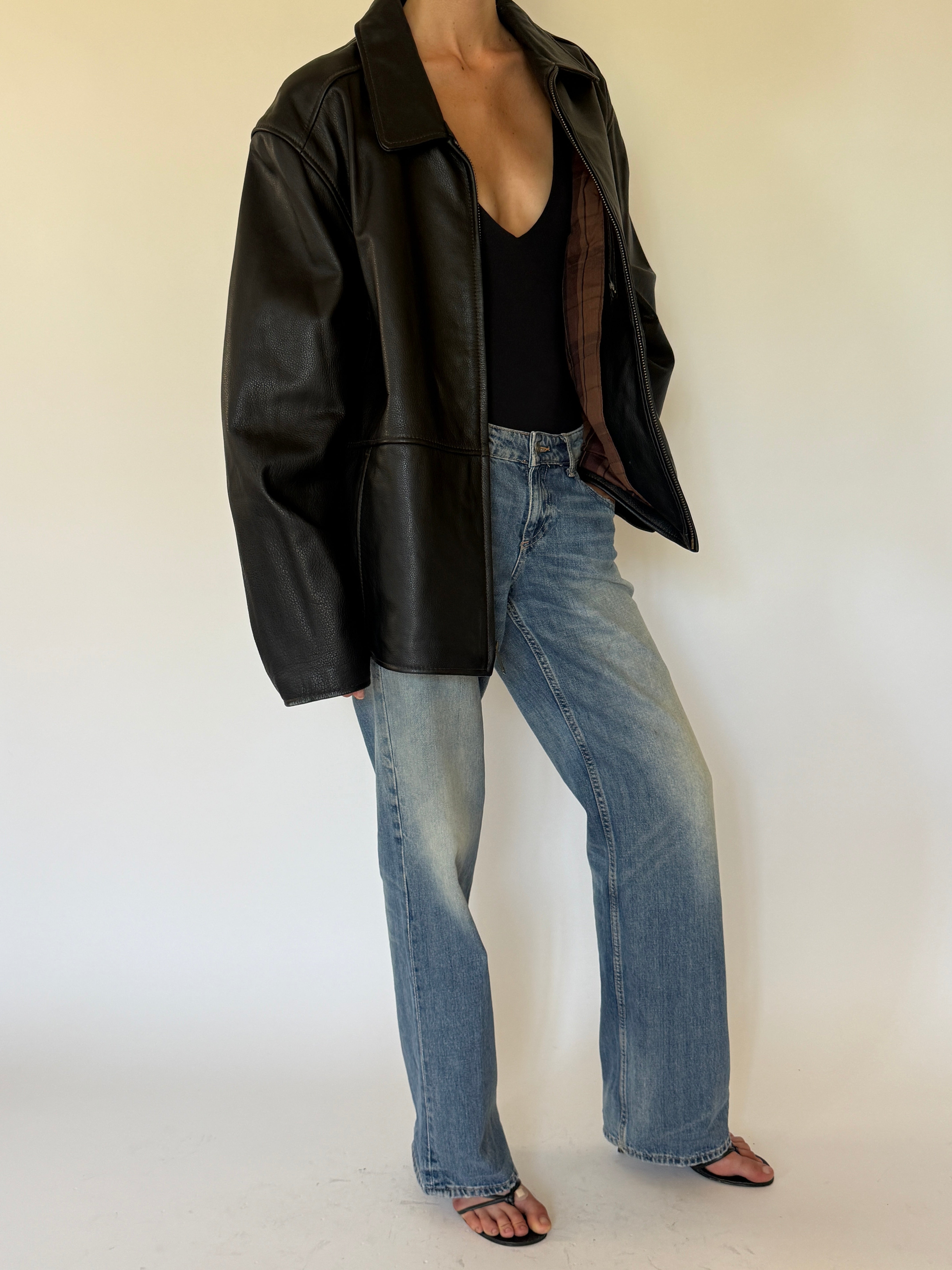 Vintage oversized black leather jacket side view