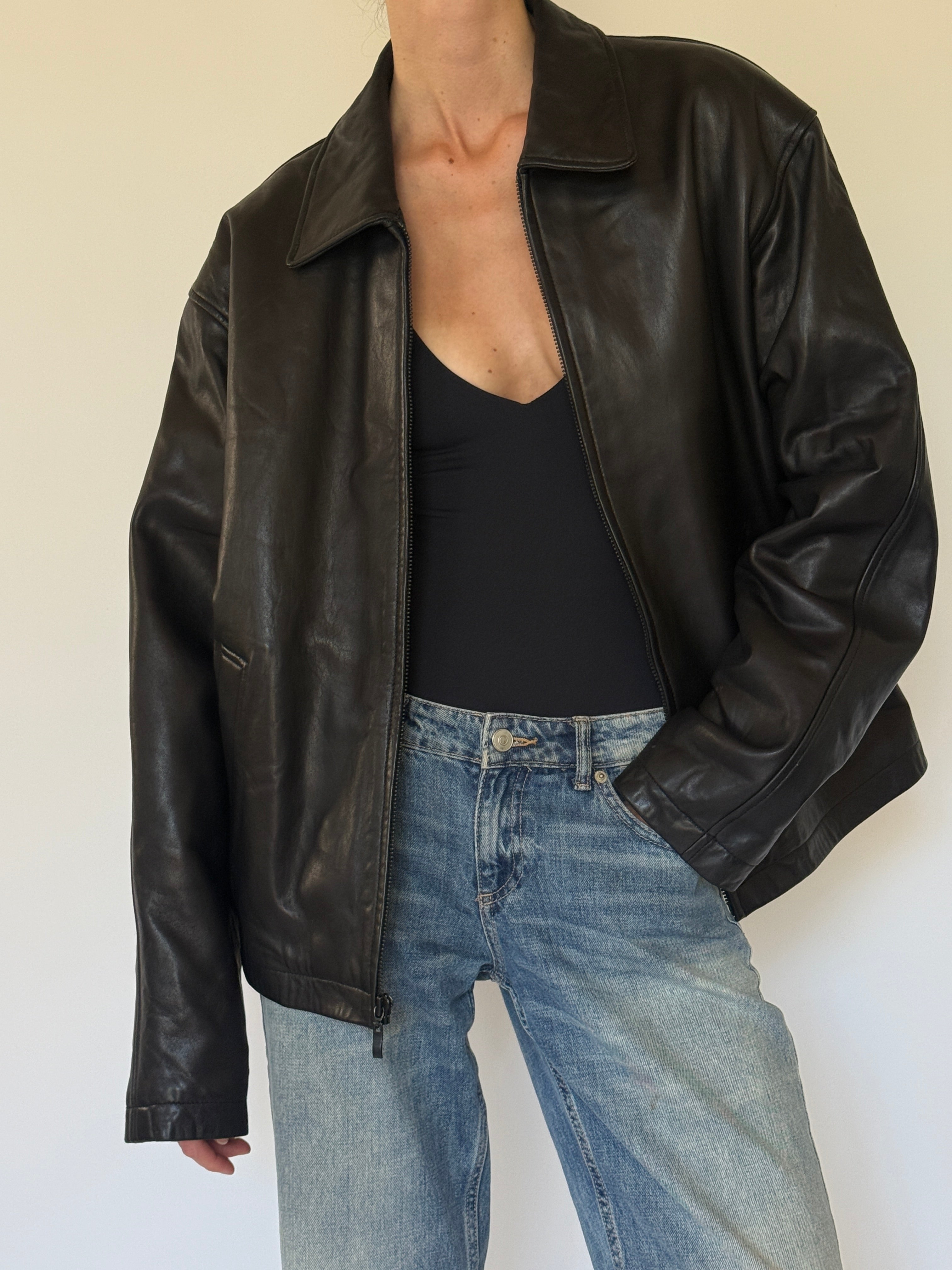 Vintage oversized black leather jacket angled front view
