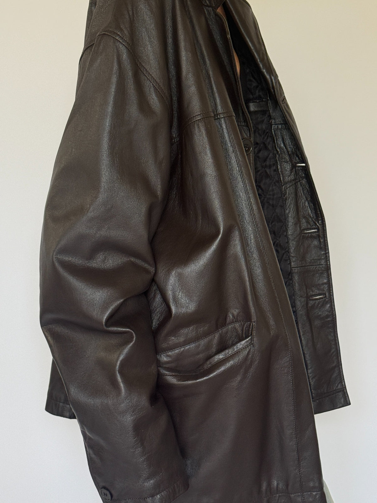 Vintage oversized dark brown leather jacket leather and pocket close-up