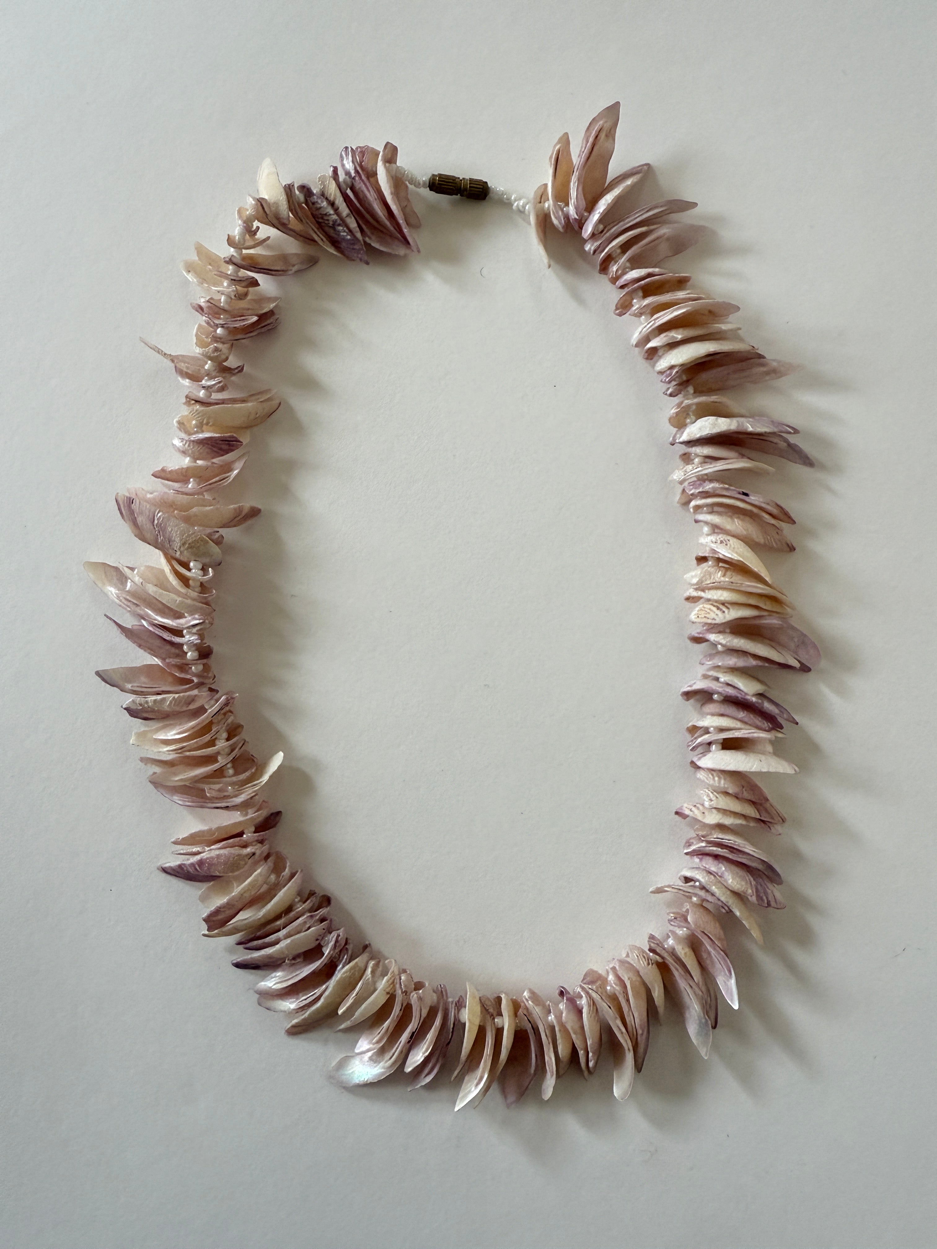Vintage pink shell chip necklace front view with layered natural shell pieces