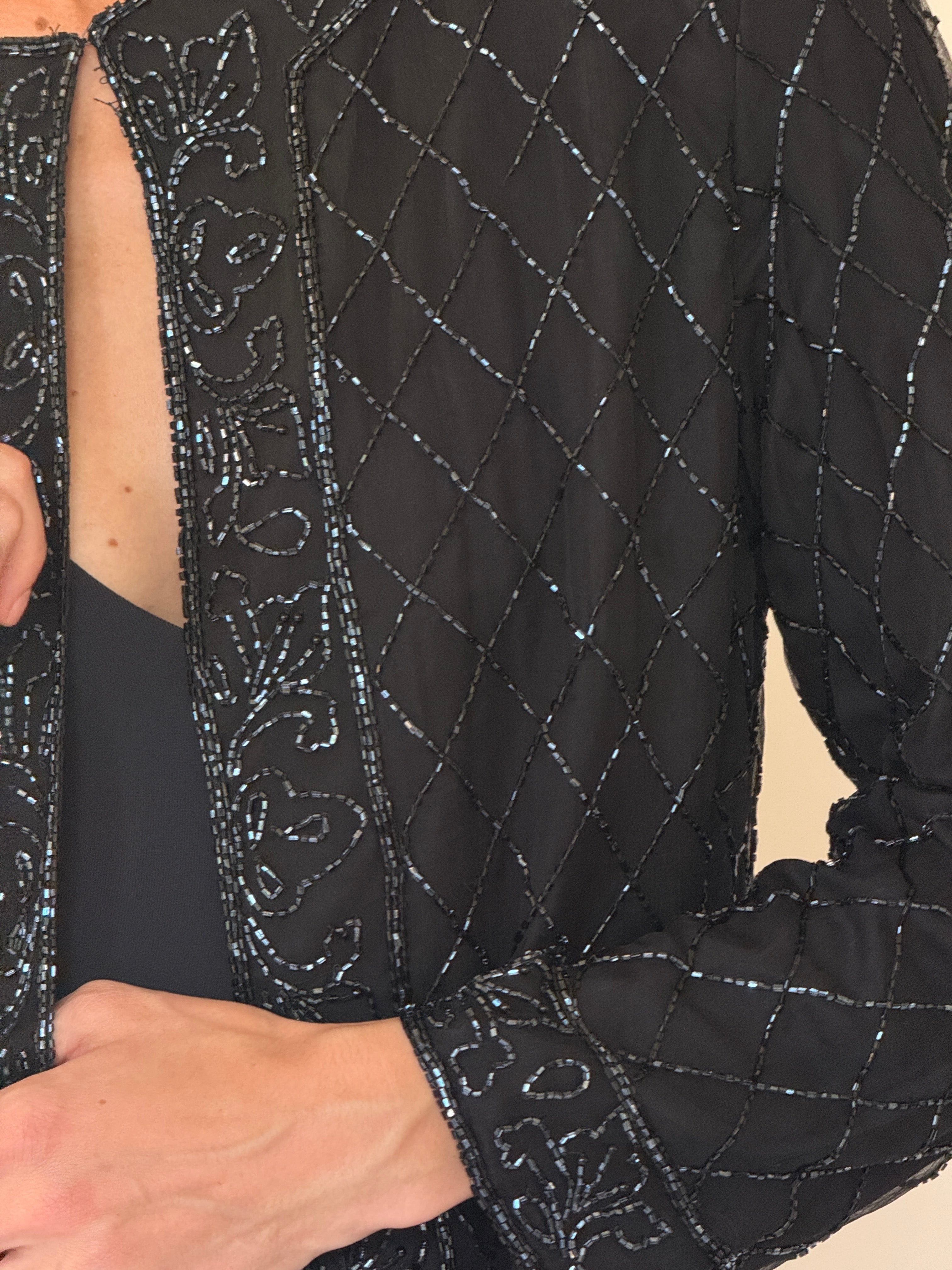 Vintage hand-beaded silk fabric close-up