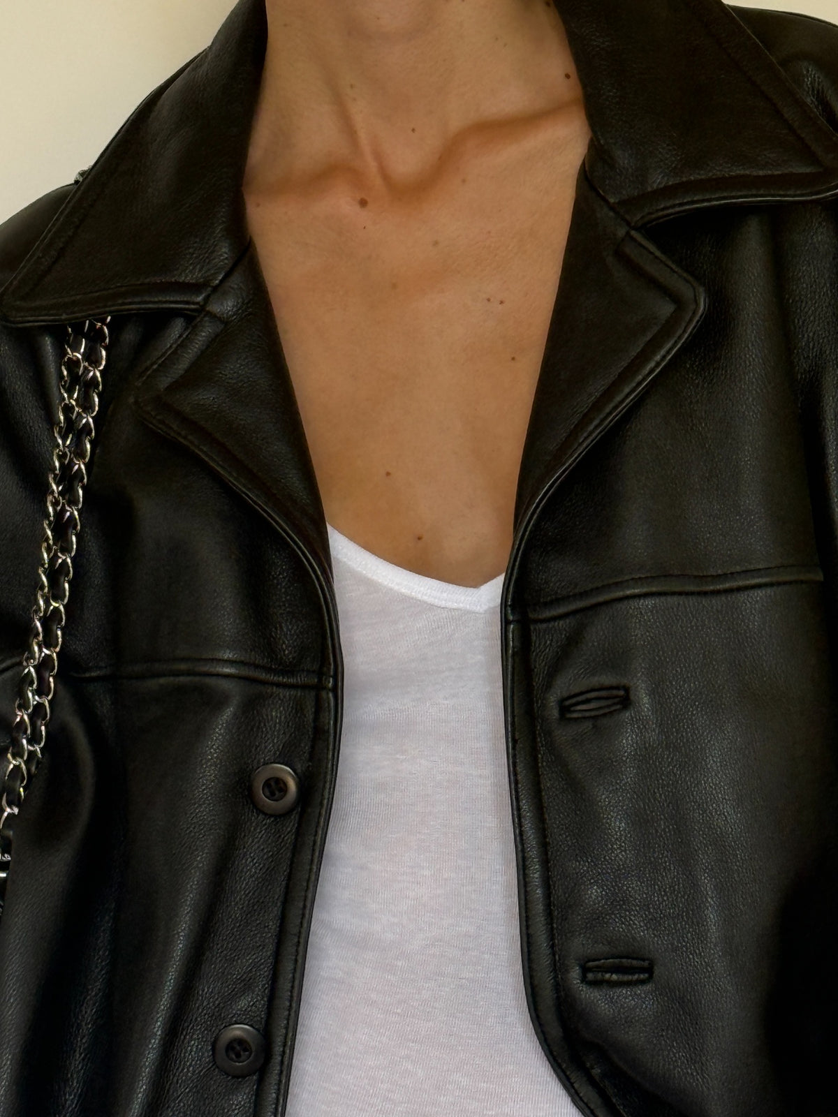 Vintage black leather jacket lapel detail