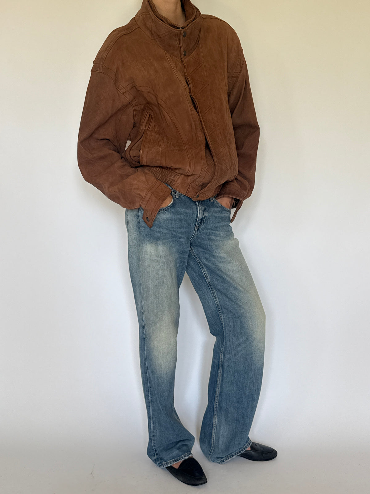Vintage brown leather bomber jacket side view