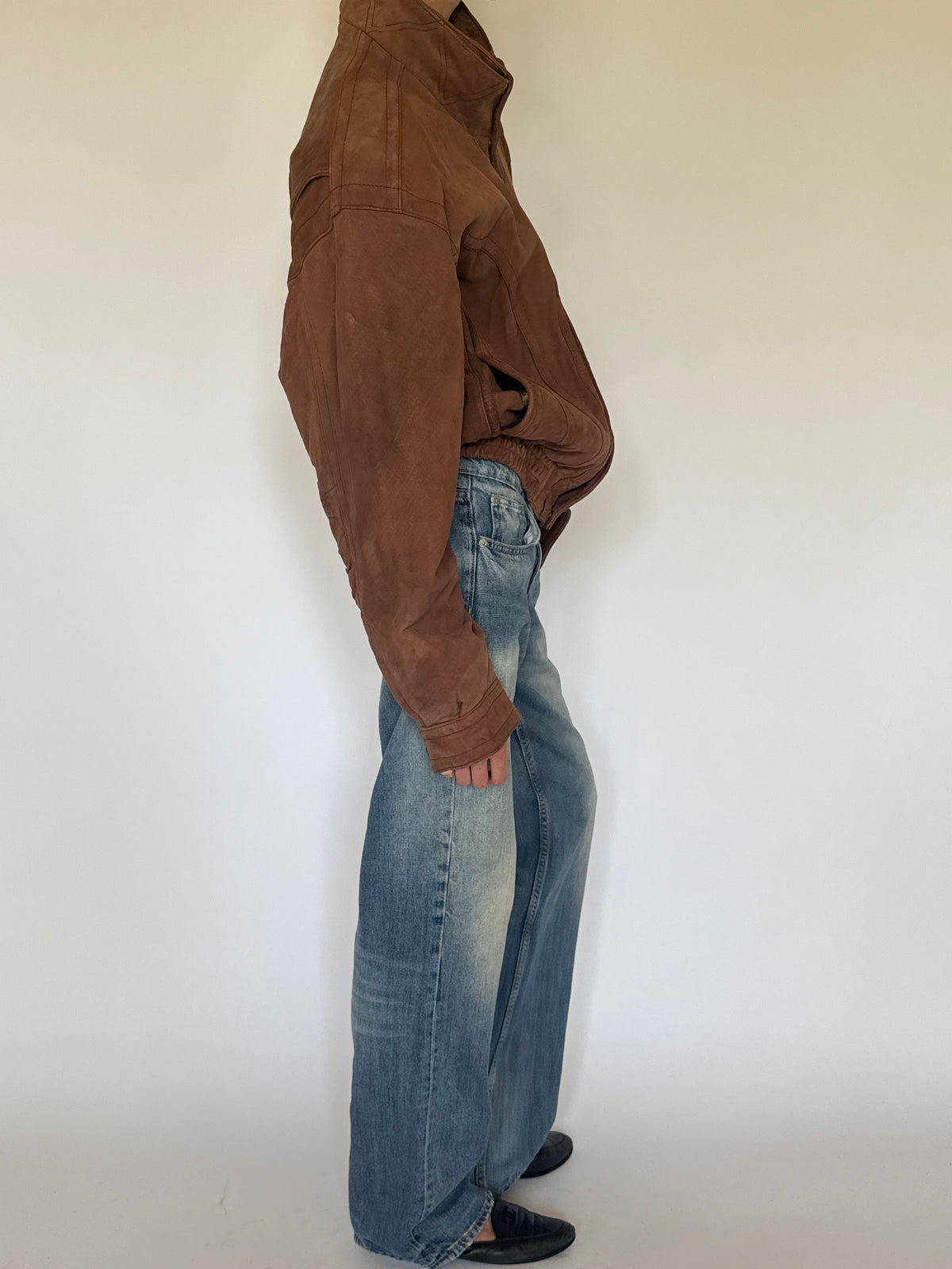 Vintage brown leather bomber jacket side view