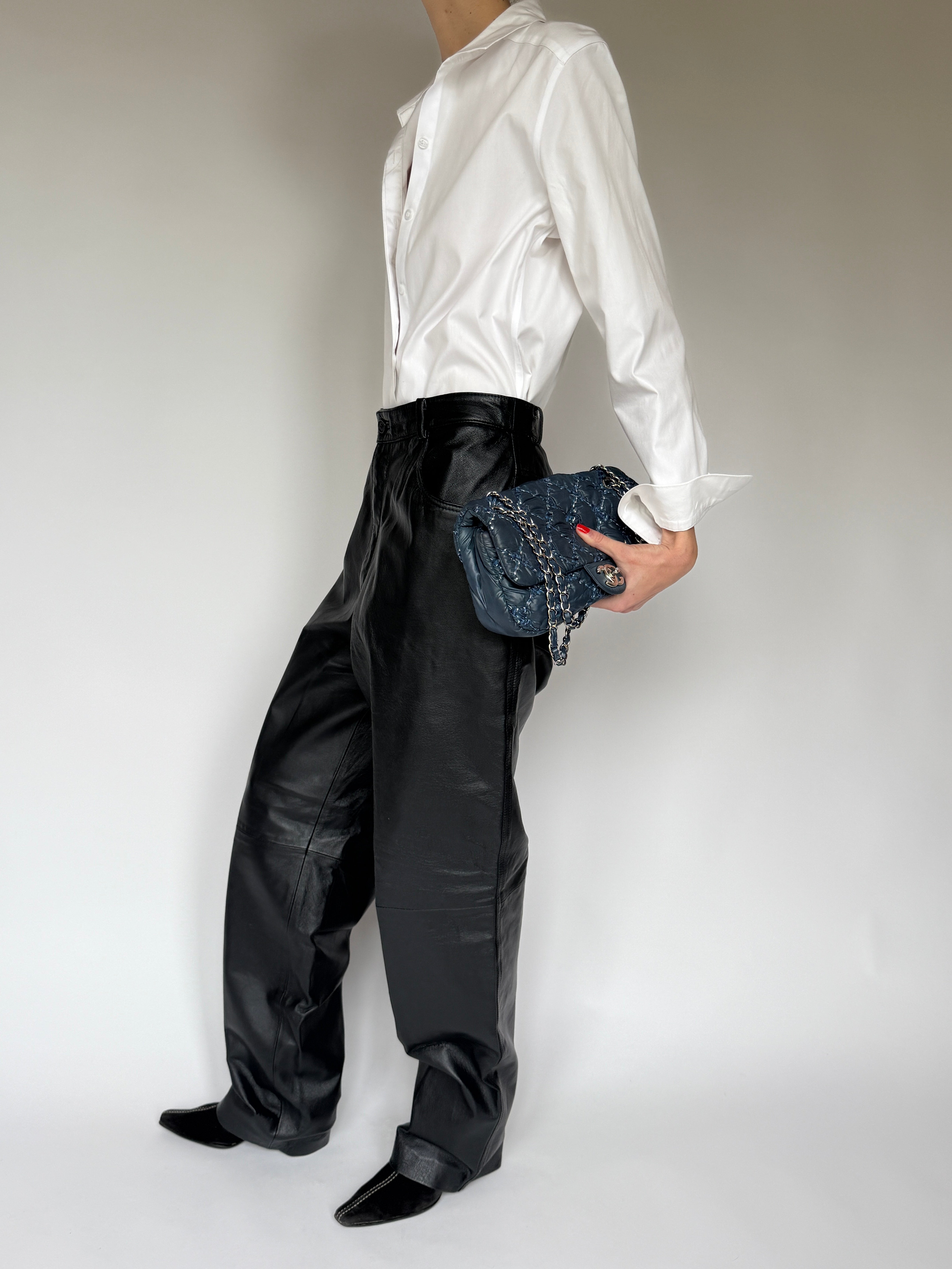 Side view of vintage black leather straight-leg pants