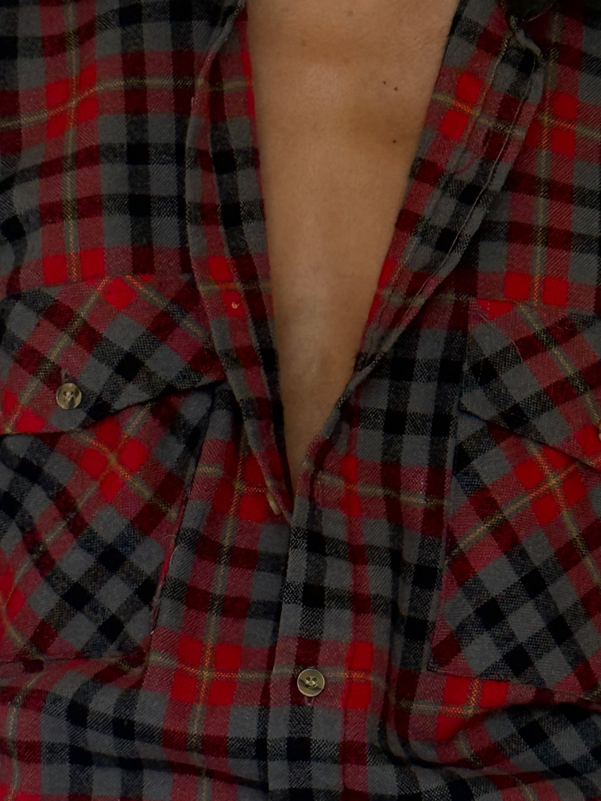 Vintage red charcoal plaid flannel fabric close-up