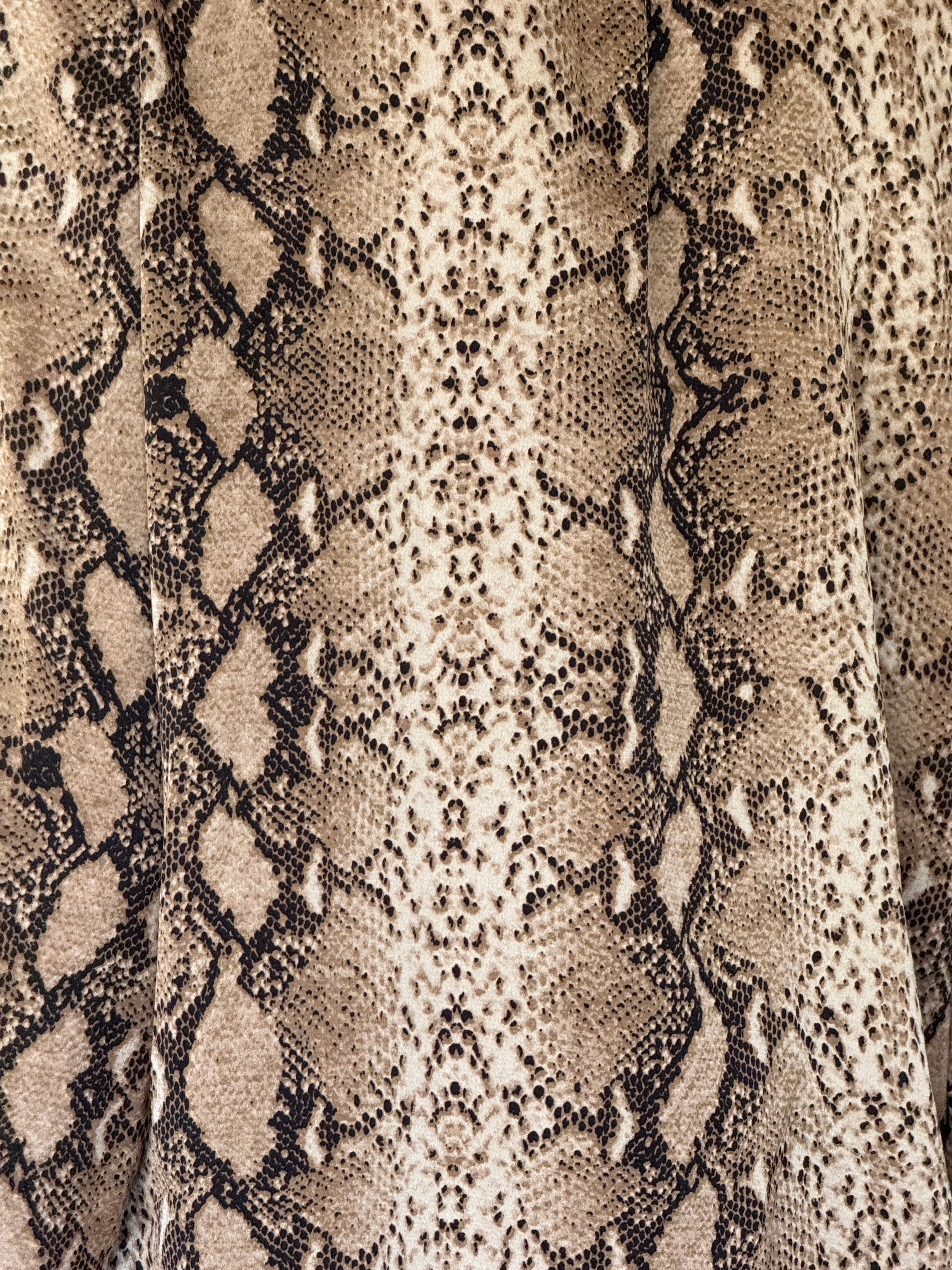 Vintage snake print button-up shirt fabric close-up