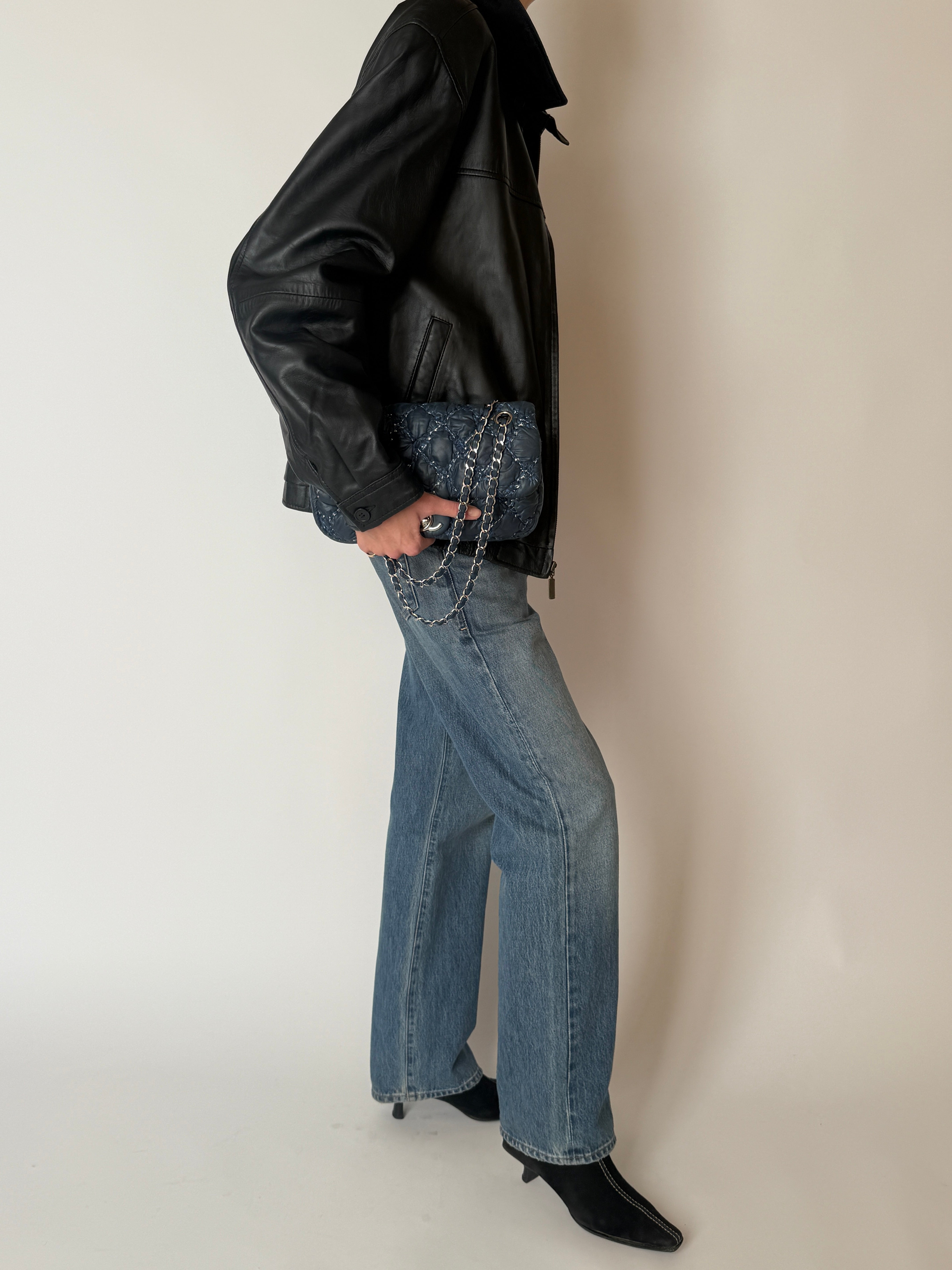 Vintage black leather zip jacket with pointed collar and elasticated hem side view