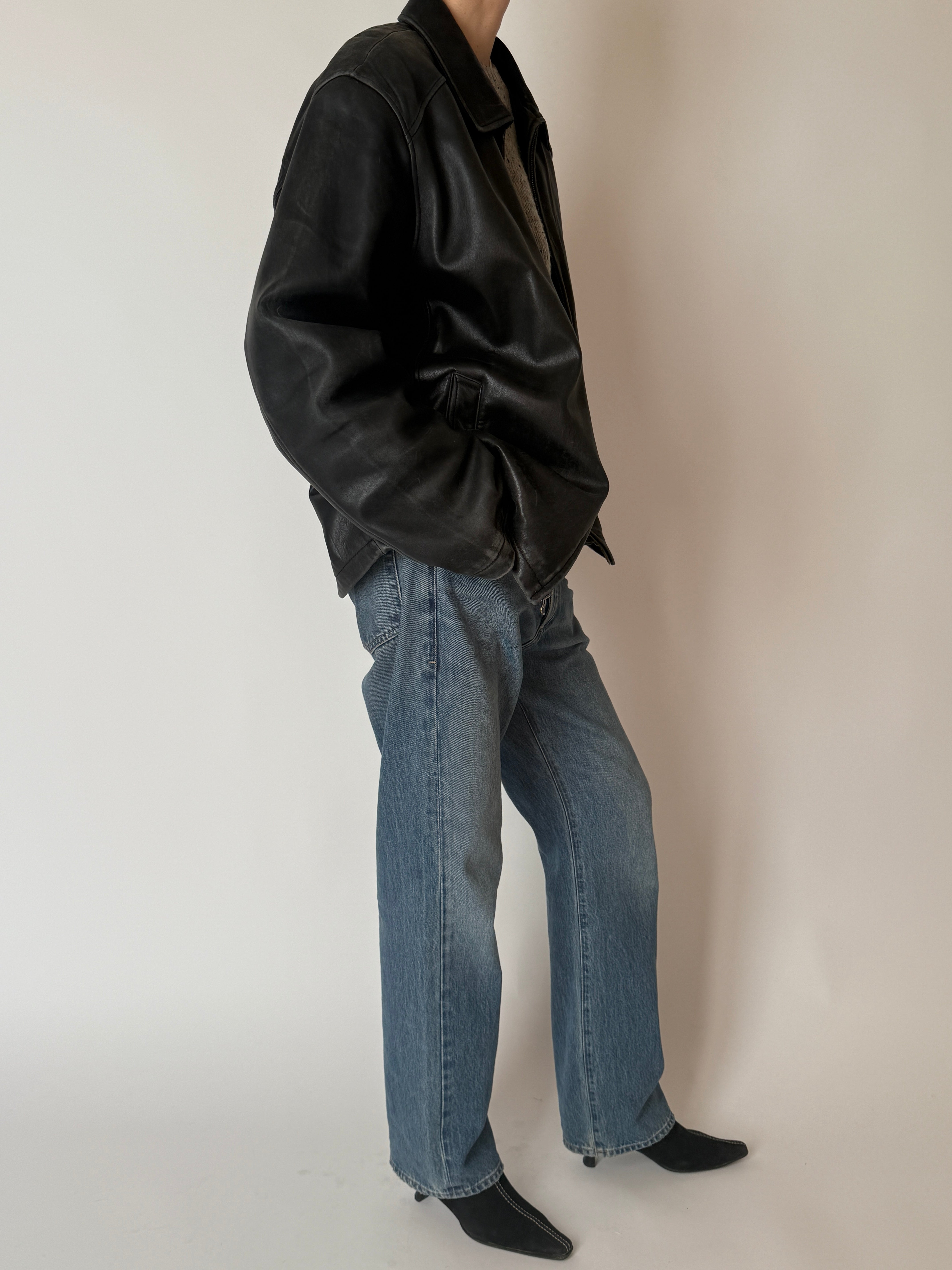 Vintage leather jacket with relaxed fit and natural wear side view full body