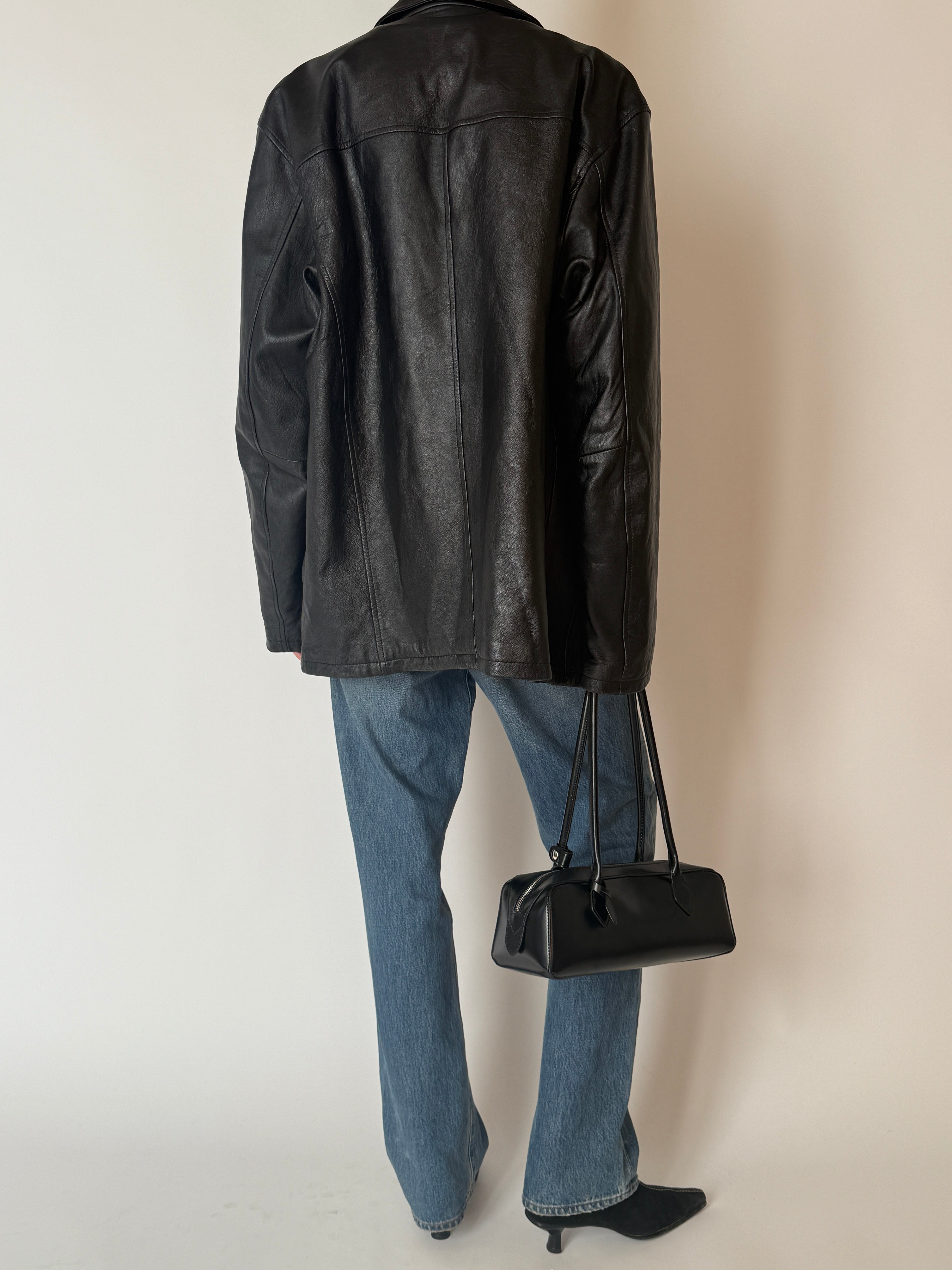 Vintage black zip-front leather jacket, back view