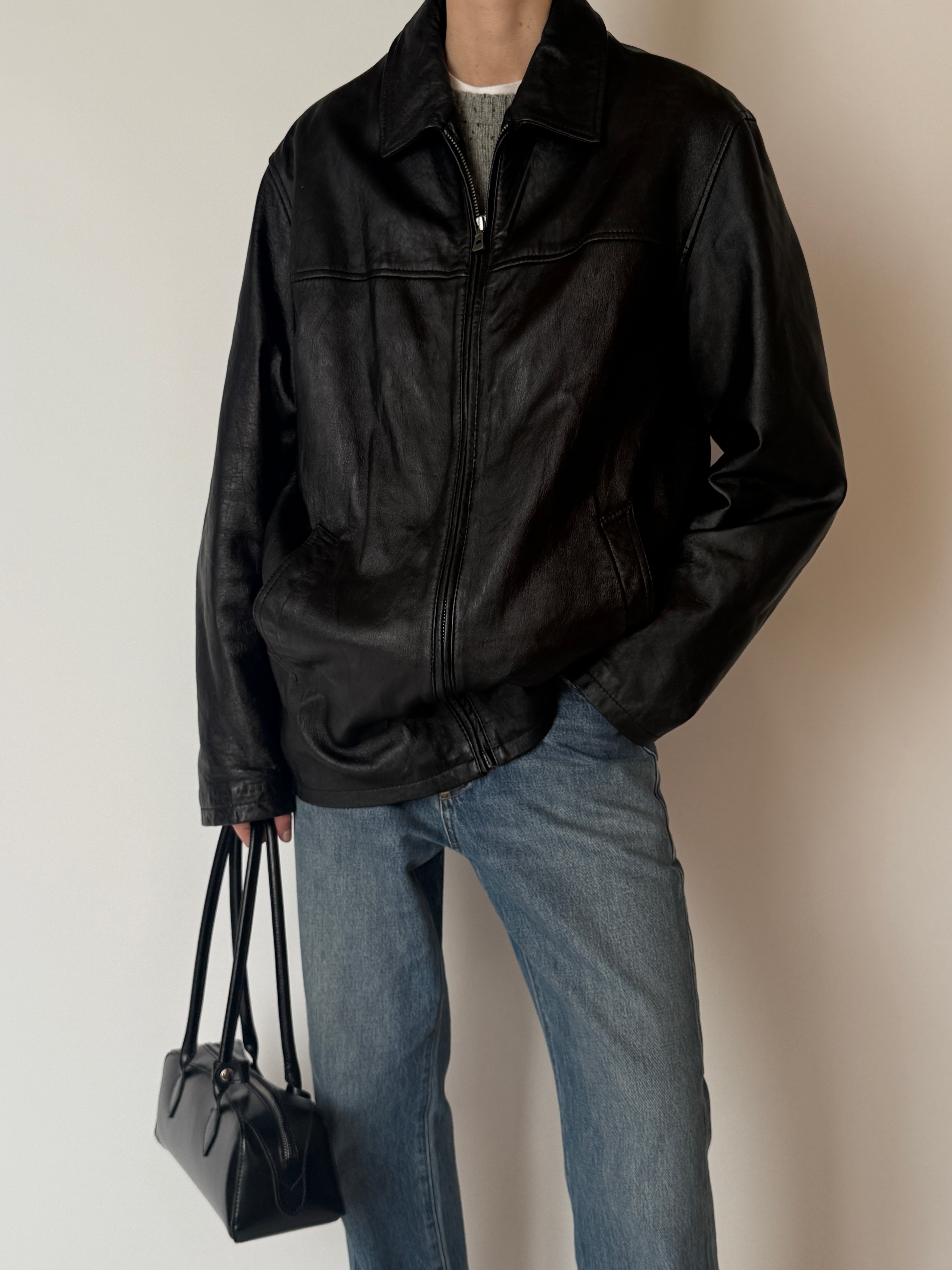 Vintage black zip-front leather jacket, front view