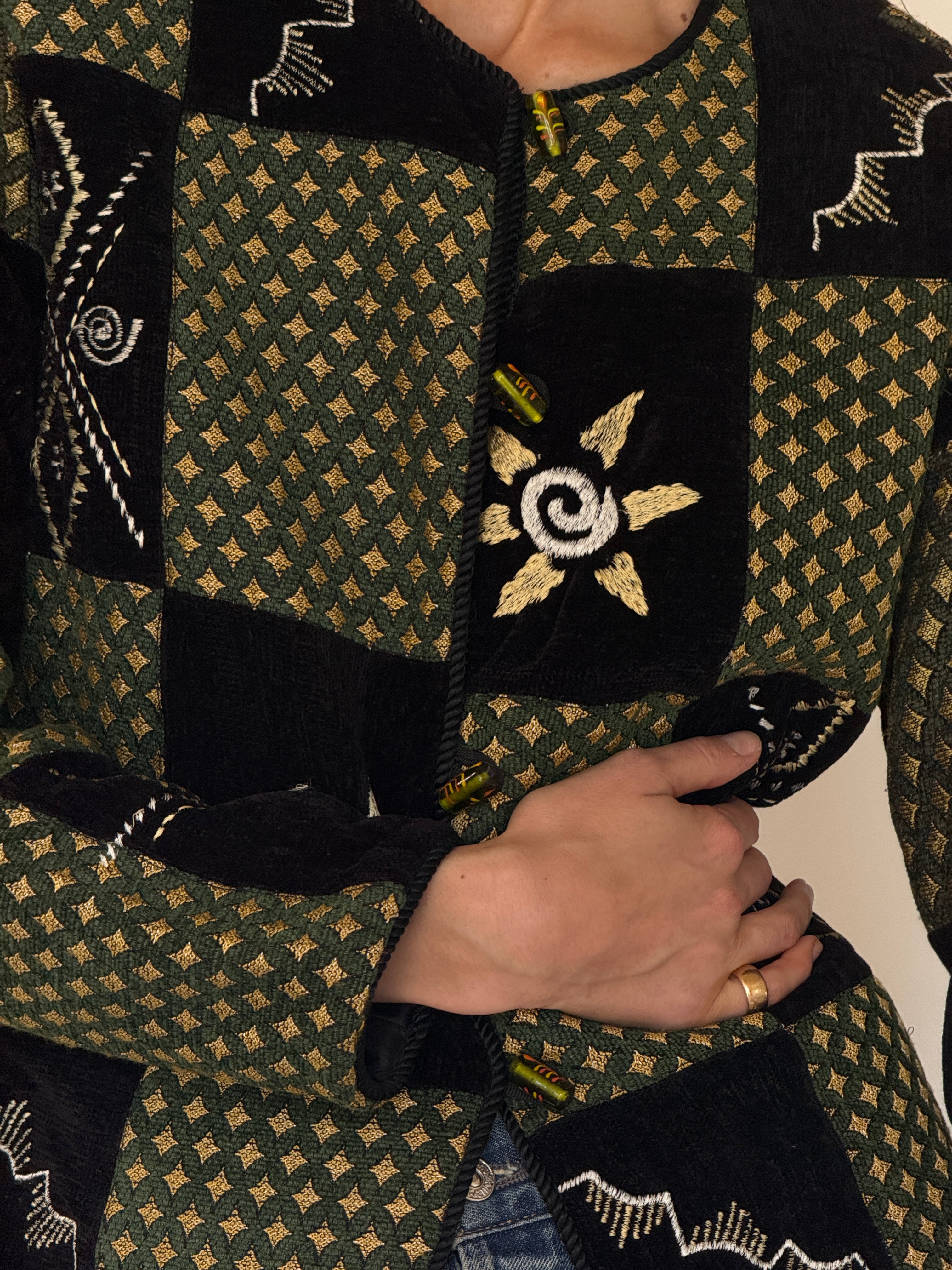 Vintage green patchwork jacket fabric texture close-up