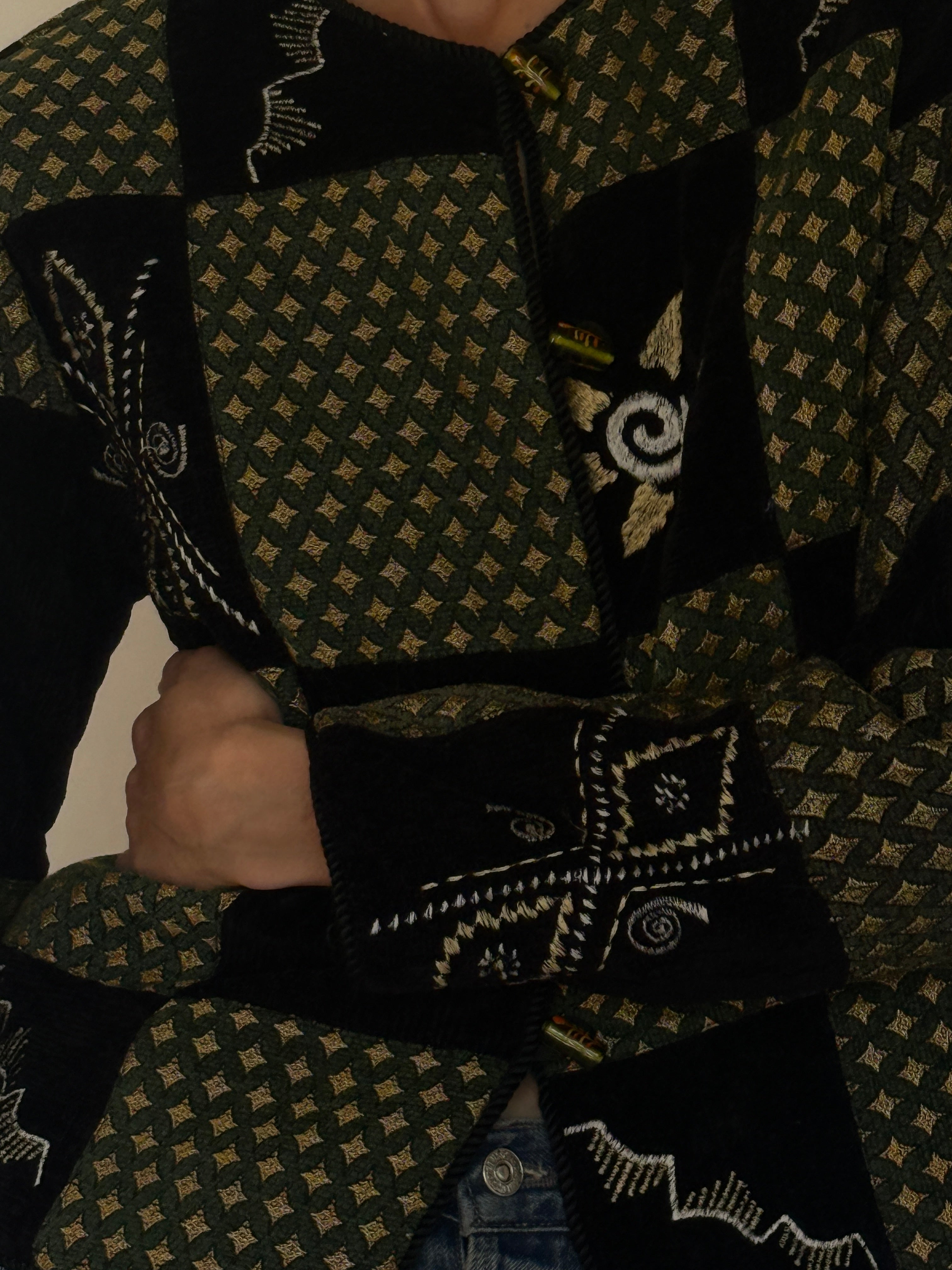 Vintage green patchwork jacket fabric texture close-up