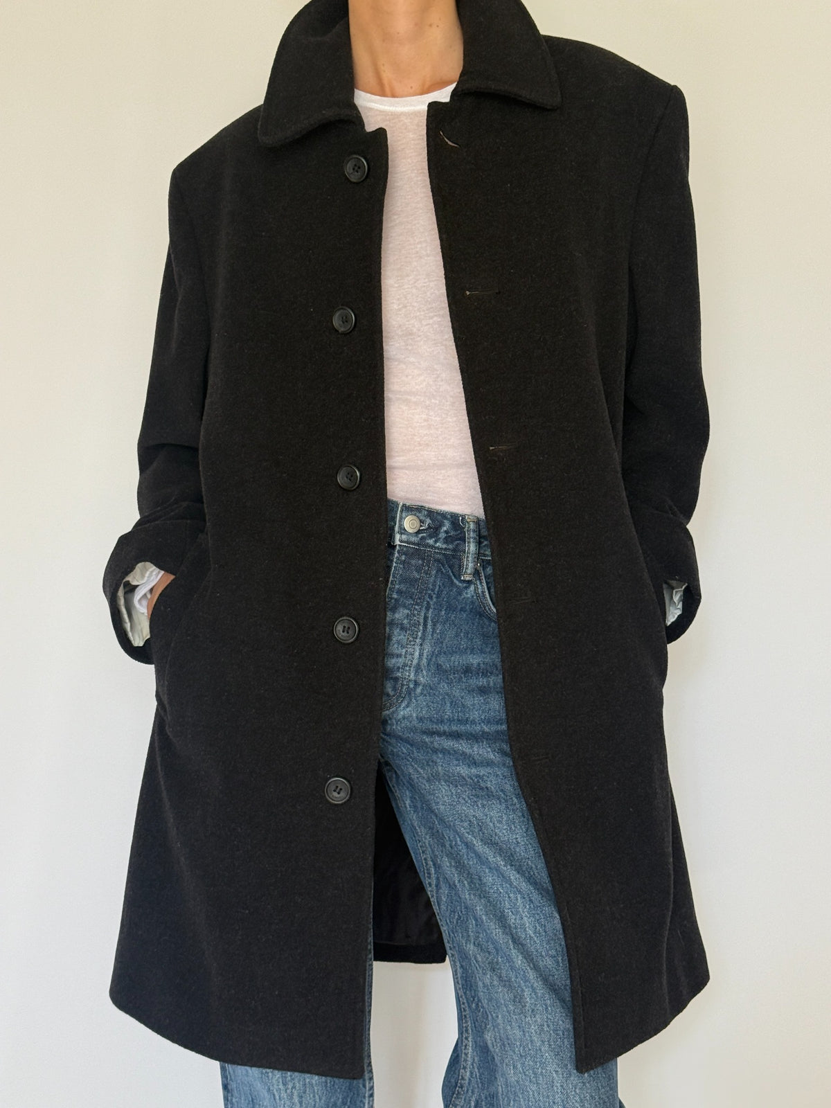 Vintage black wool blend coat fabric close-up