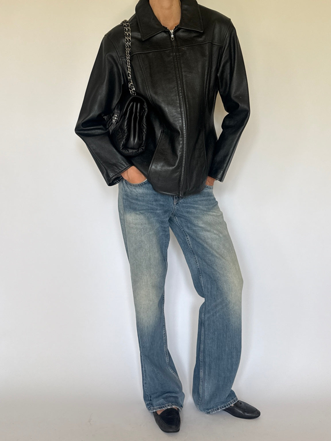 Black leather jacket styled with jeans, full-length front view