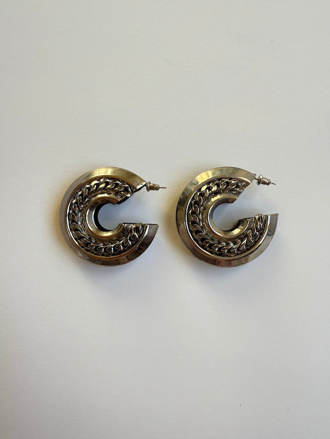 Crescent-shaped hoop earring with a polished silver-tone finish earring