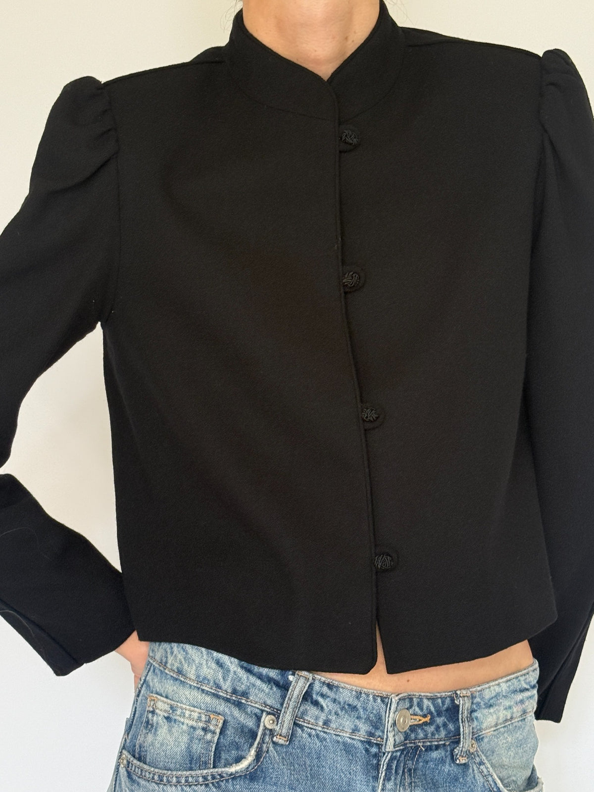 Vintage black wool jacket front detail with stand collar and four frog closures