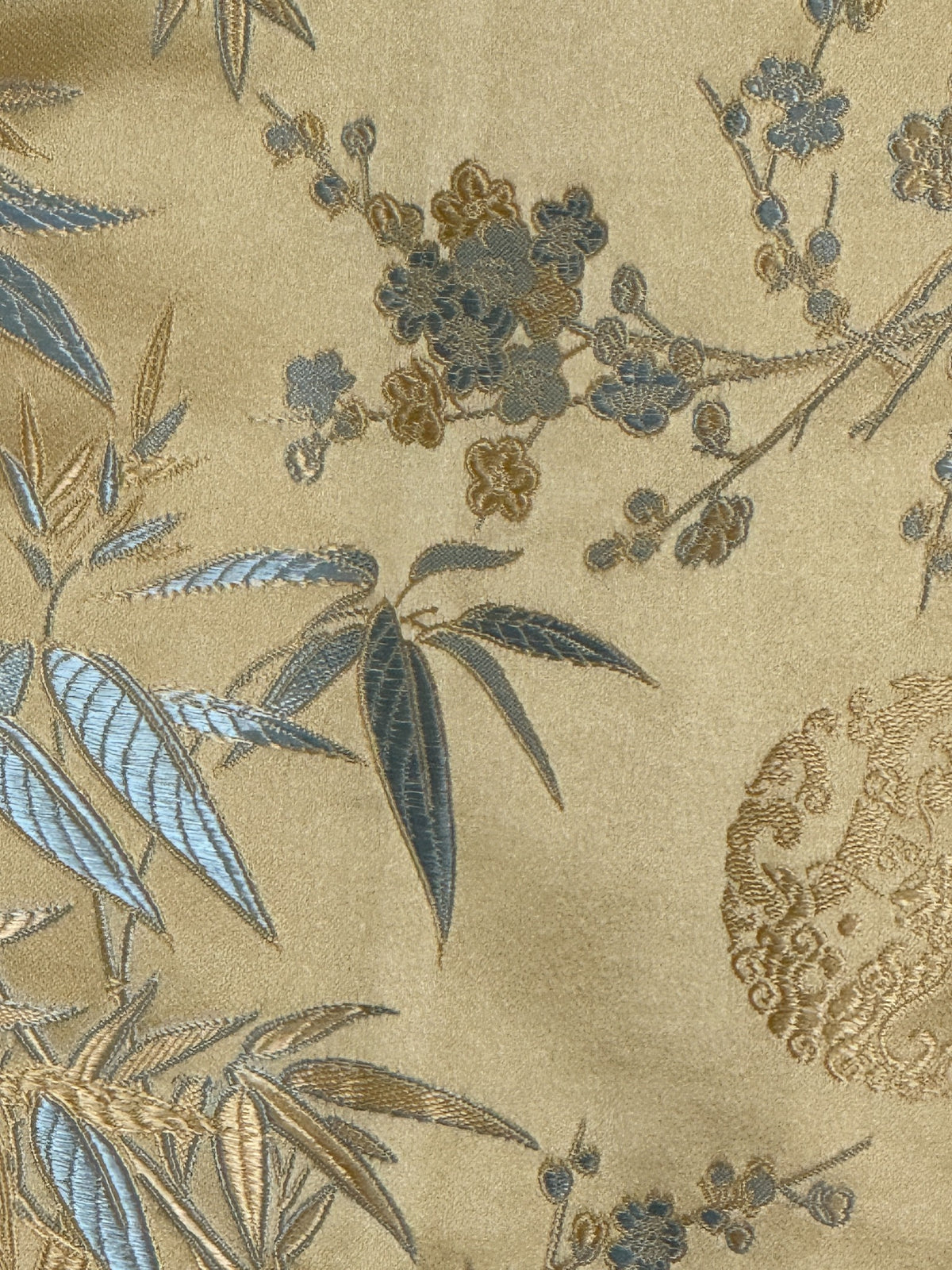 Vintage gold and blue brocade fabric close-up