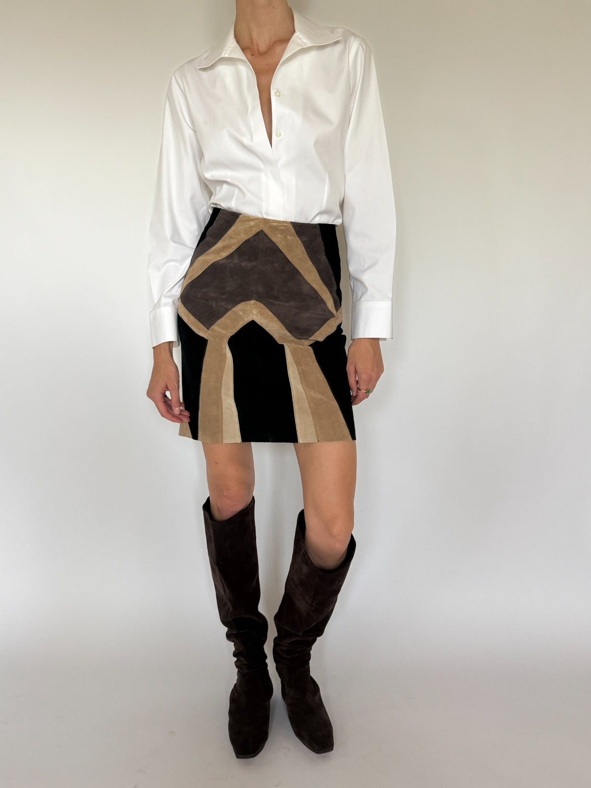 Vintage patchwork leather mini skirt front view styled with white shirt and boots