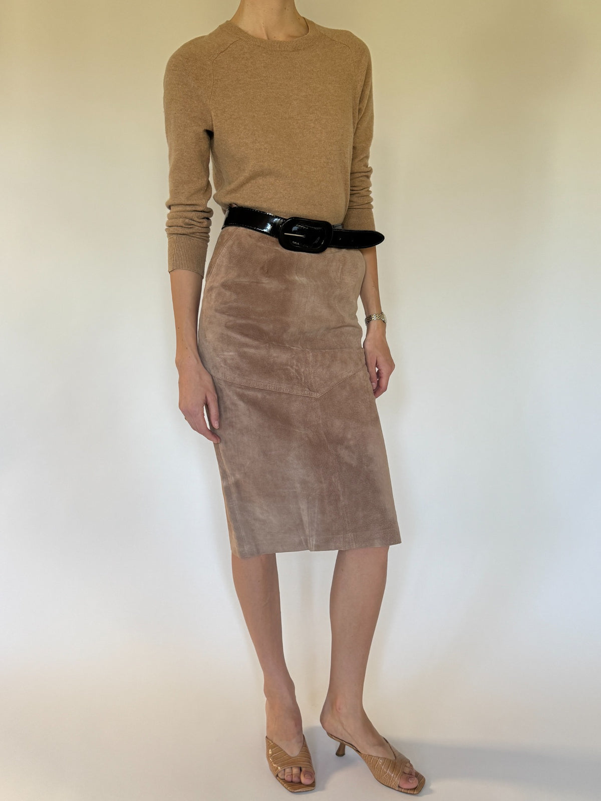 Vintage suede midi skirt close-up showing V-shaped panel construction and natural suede texture