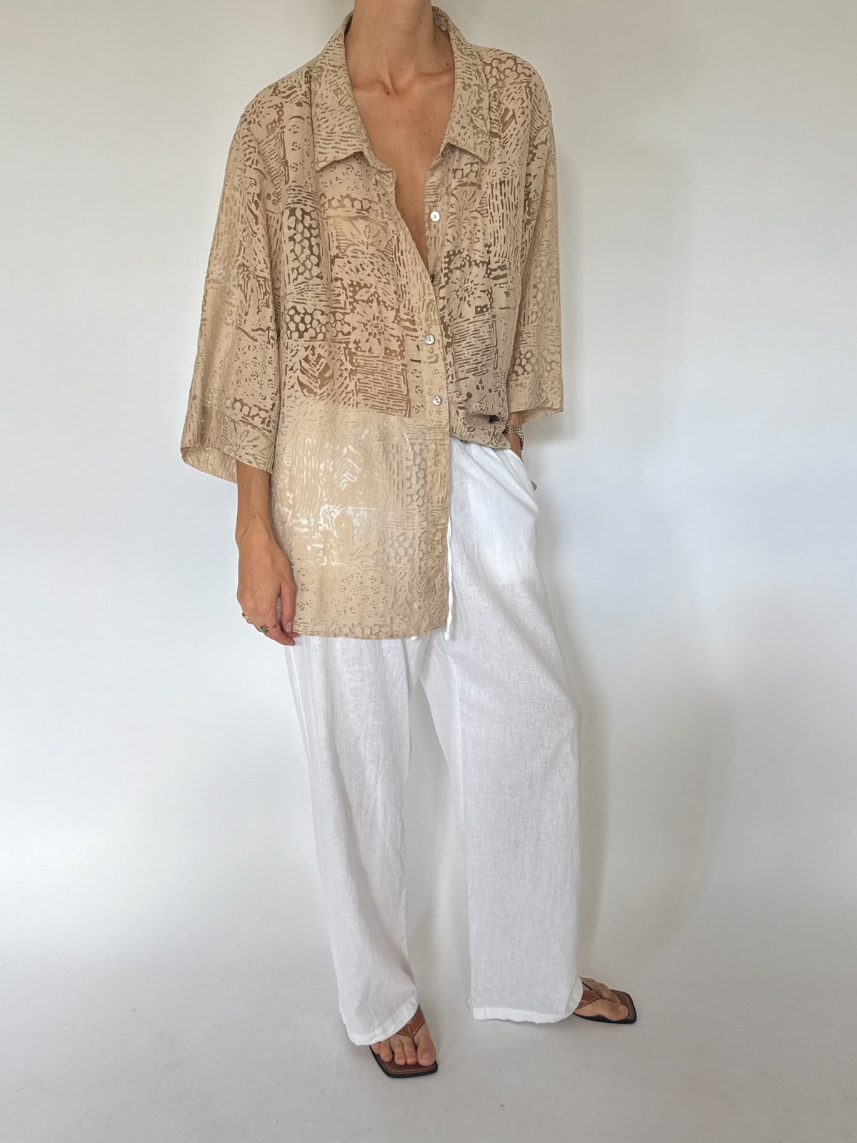 Oversized beige abstract burnout patterned button-up blouse