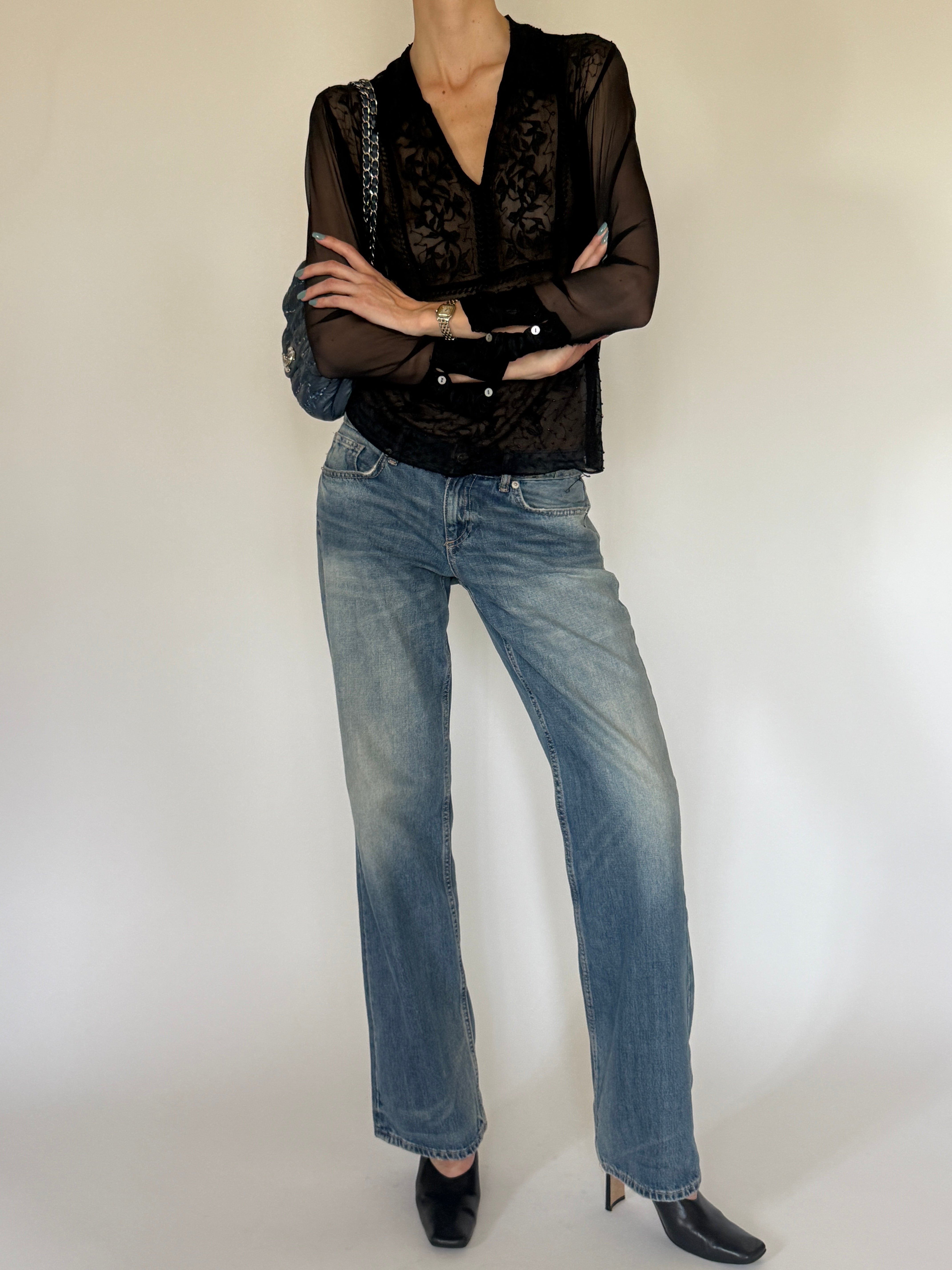 Vintage sheer black embroidered blouse close-up of floral embroidery