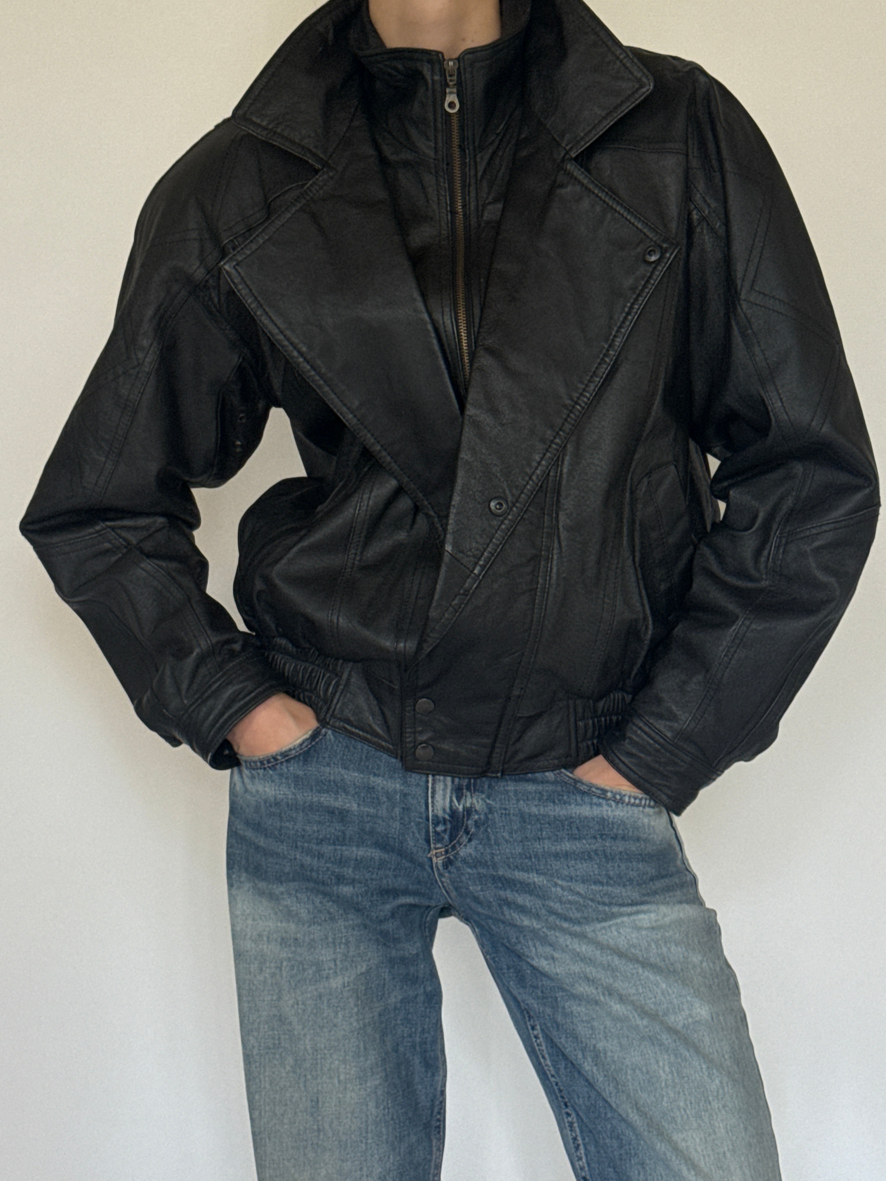 Vintage oversized black leather bomber jacket leather texture close-up