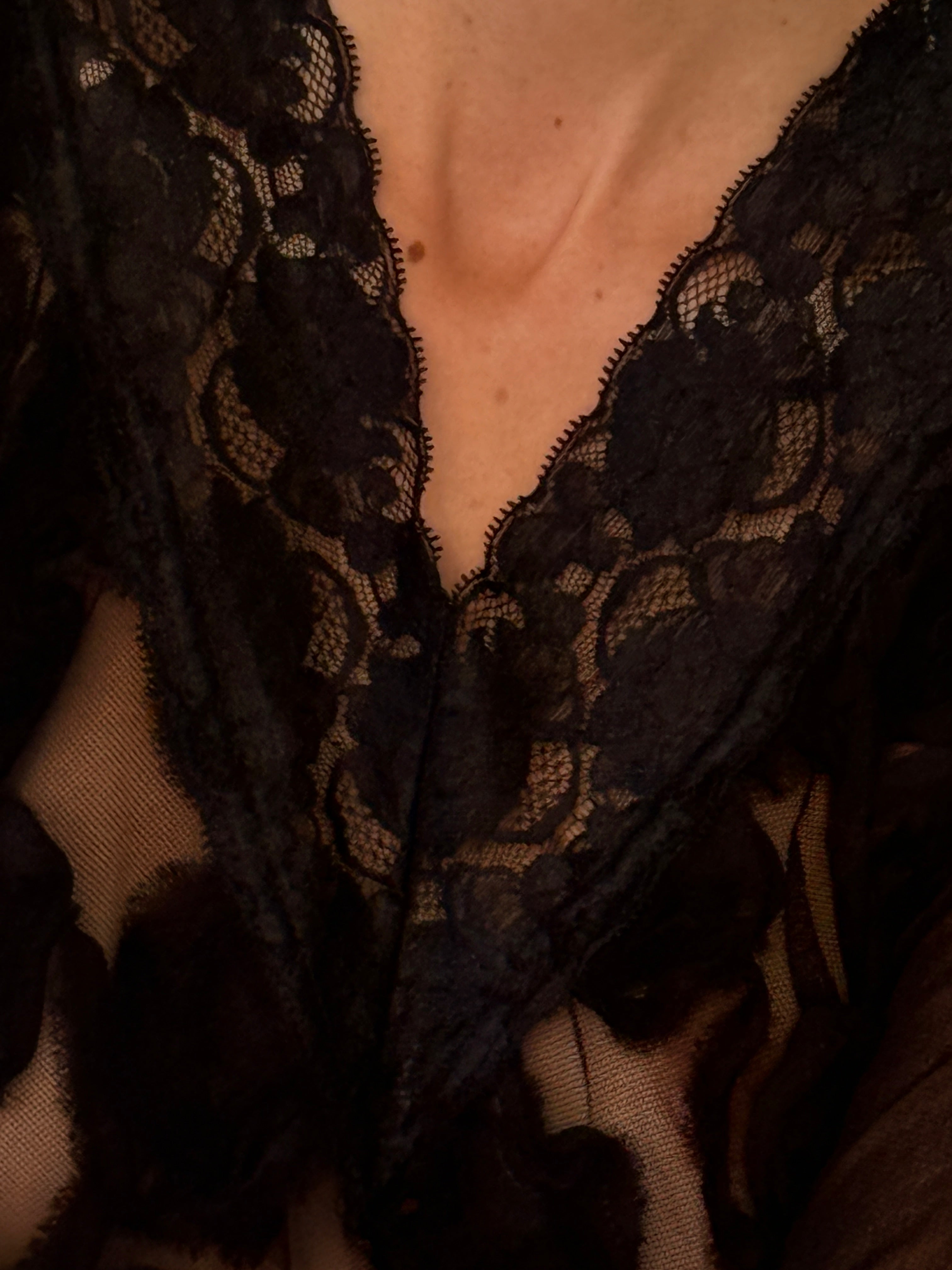 Vintage black lace V-neck detail close-up