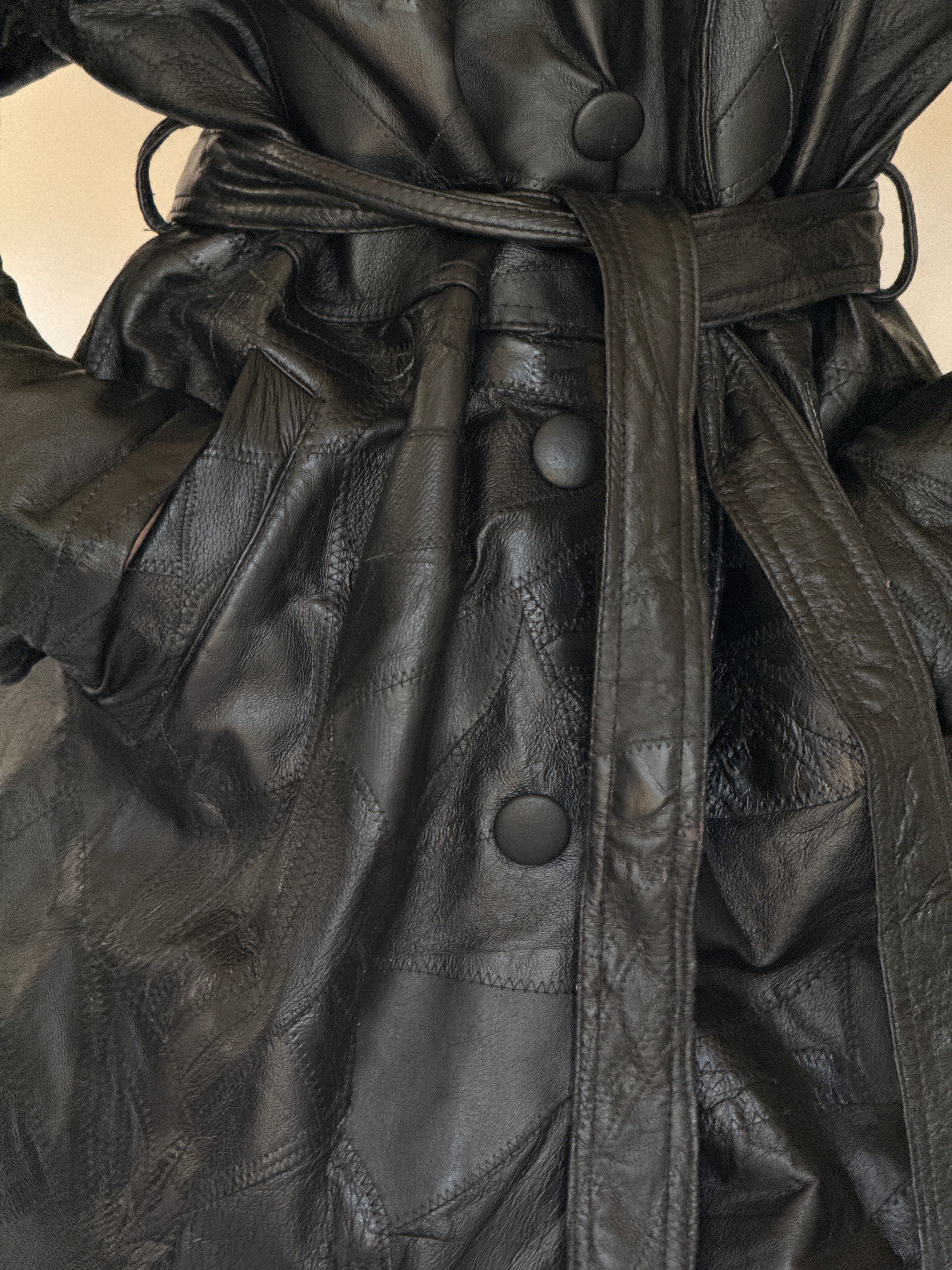 Vintage black leather trench coat belt detail