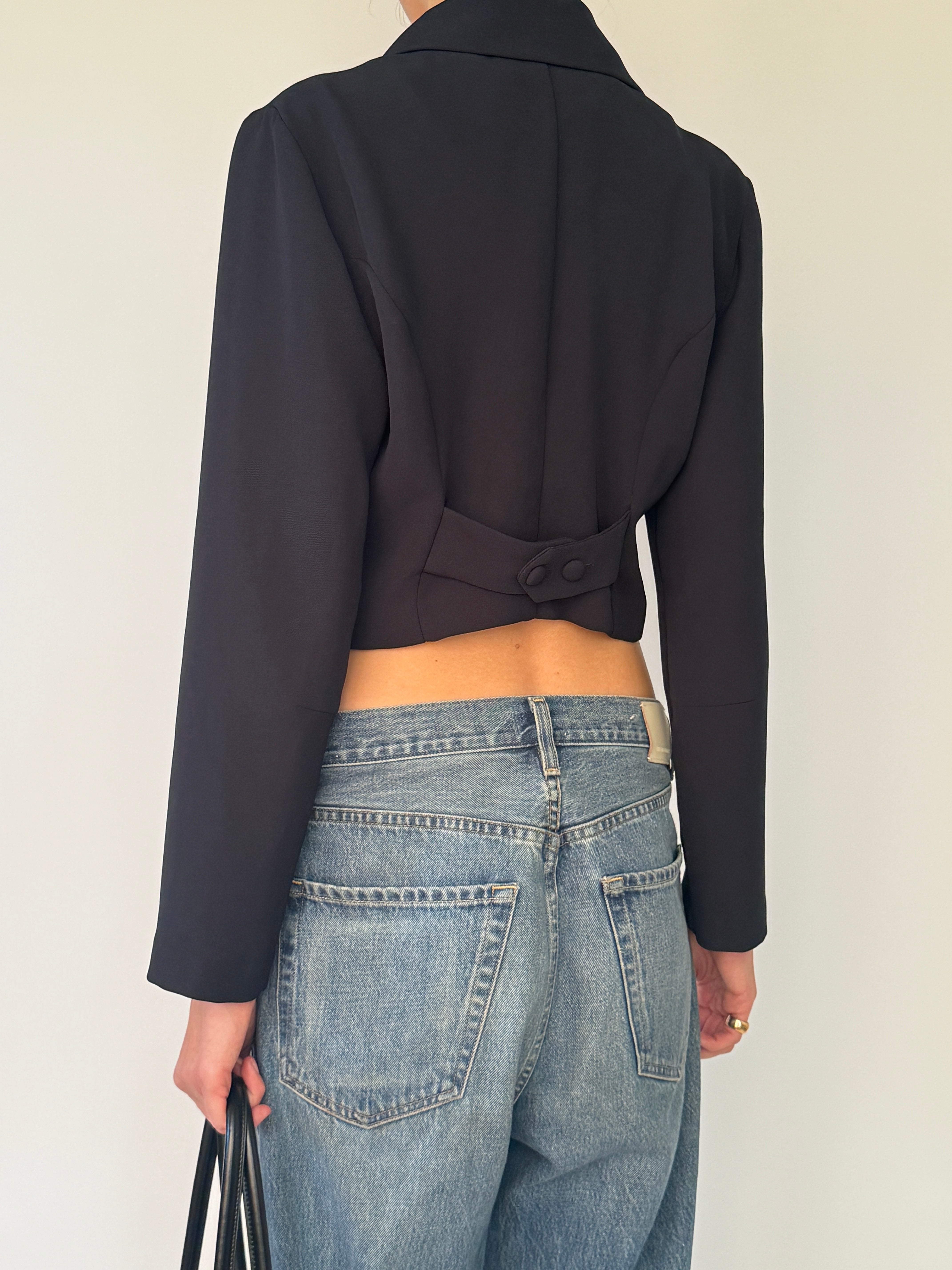 Vintage short blazer with decorative button tab detail at hem in black