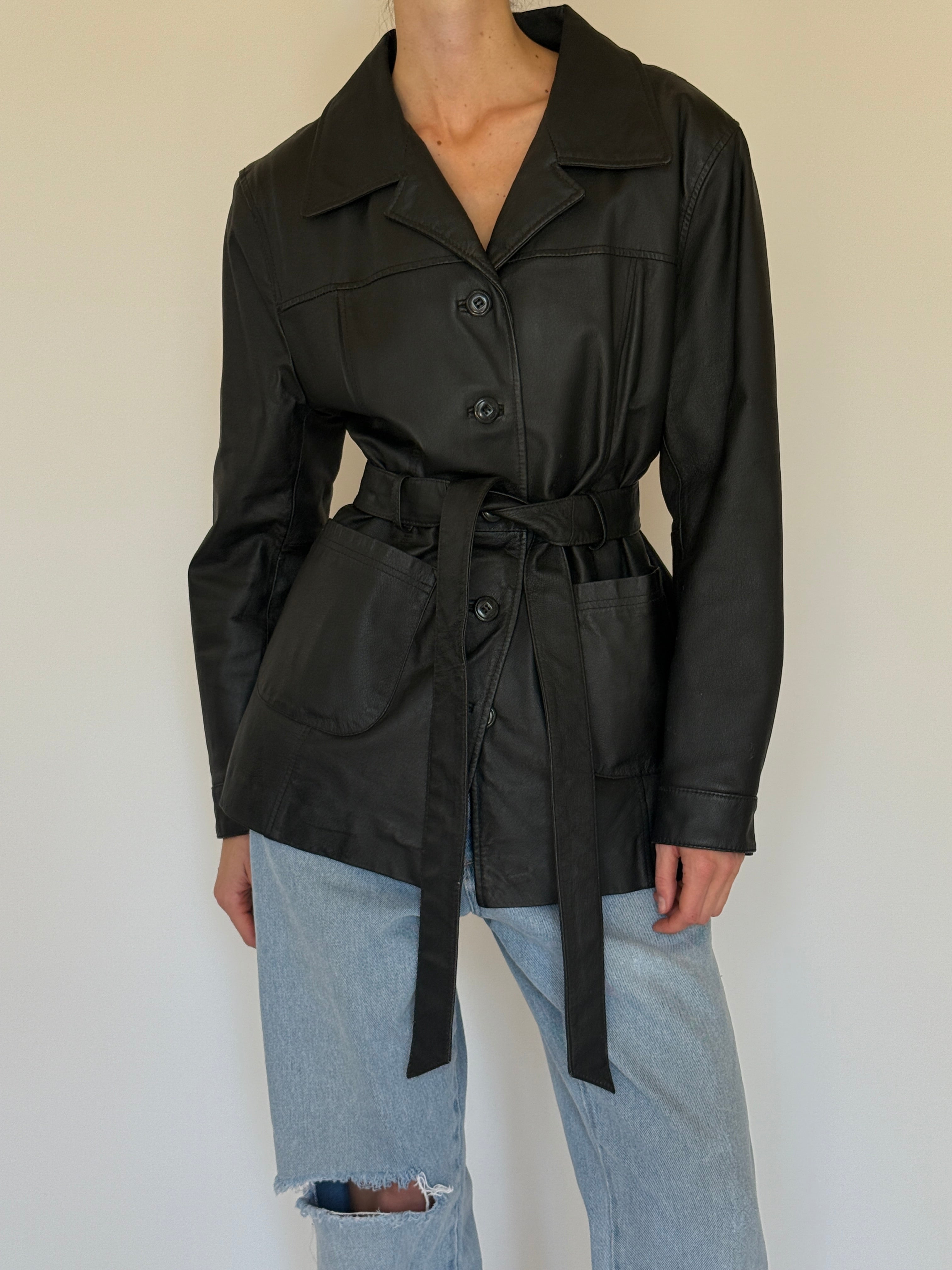 Vintage black leather jacket fabric close-up smooth leather