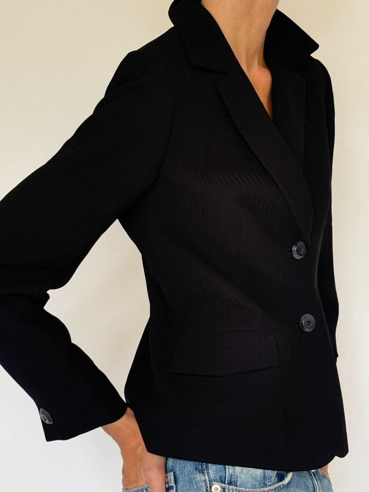 Vintage fitted black blazer lapel and button detail