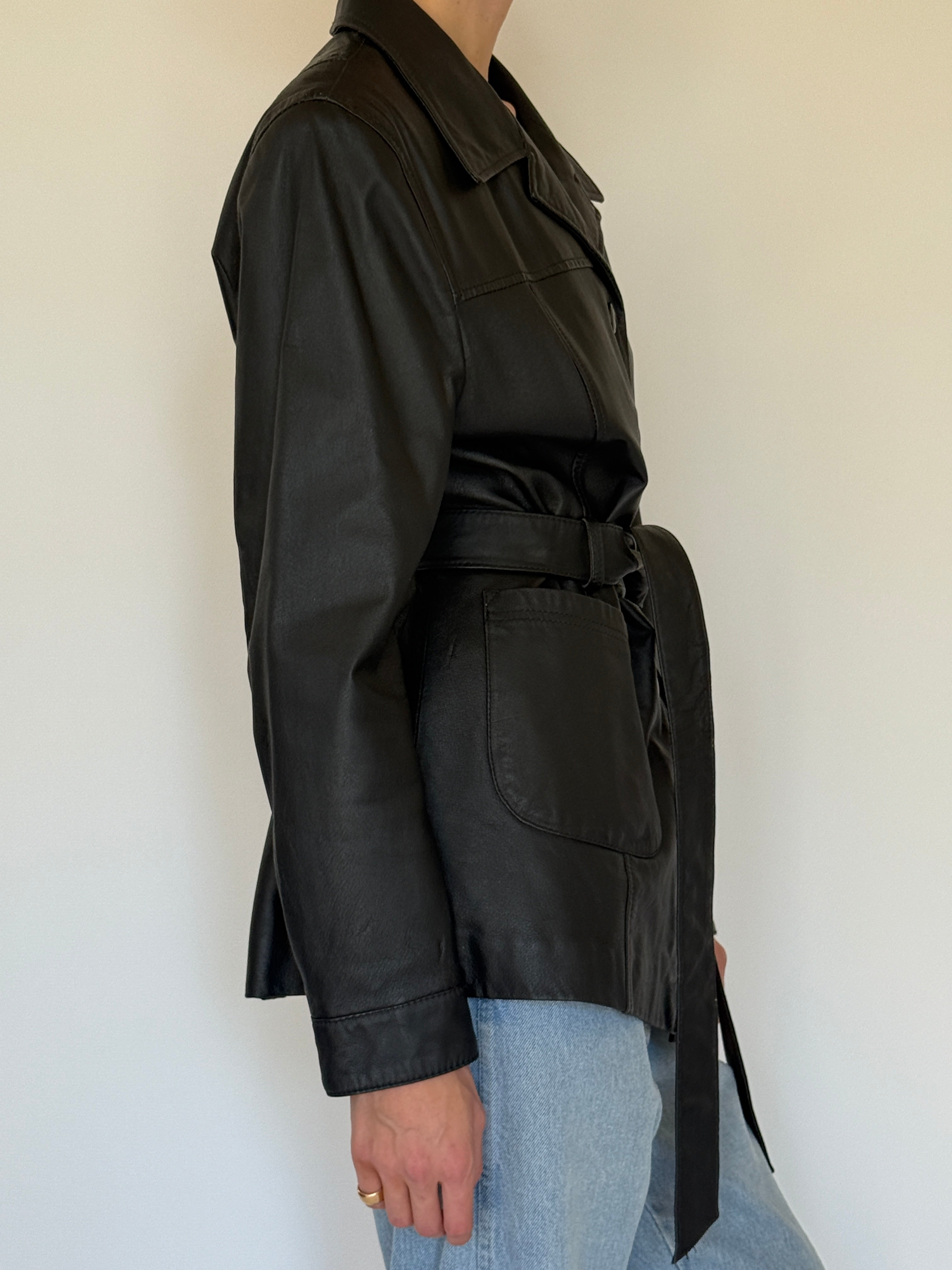 Vintage black leather jacket side view cinched waist
