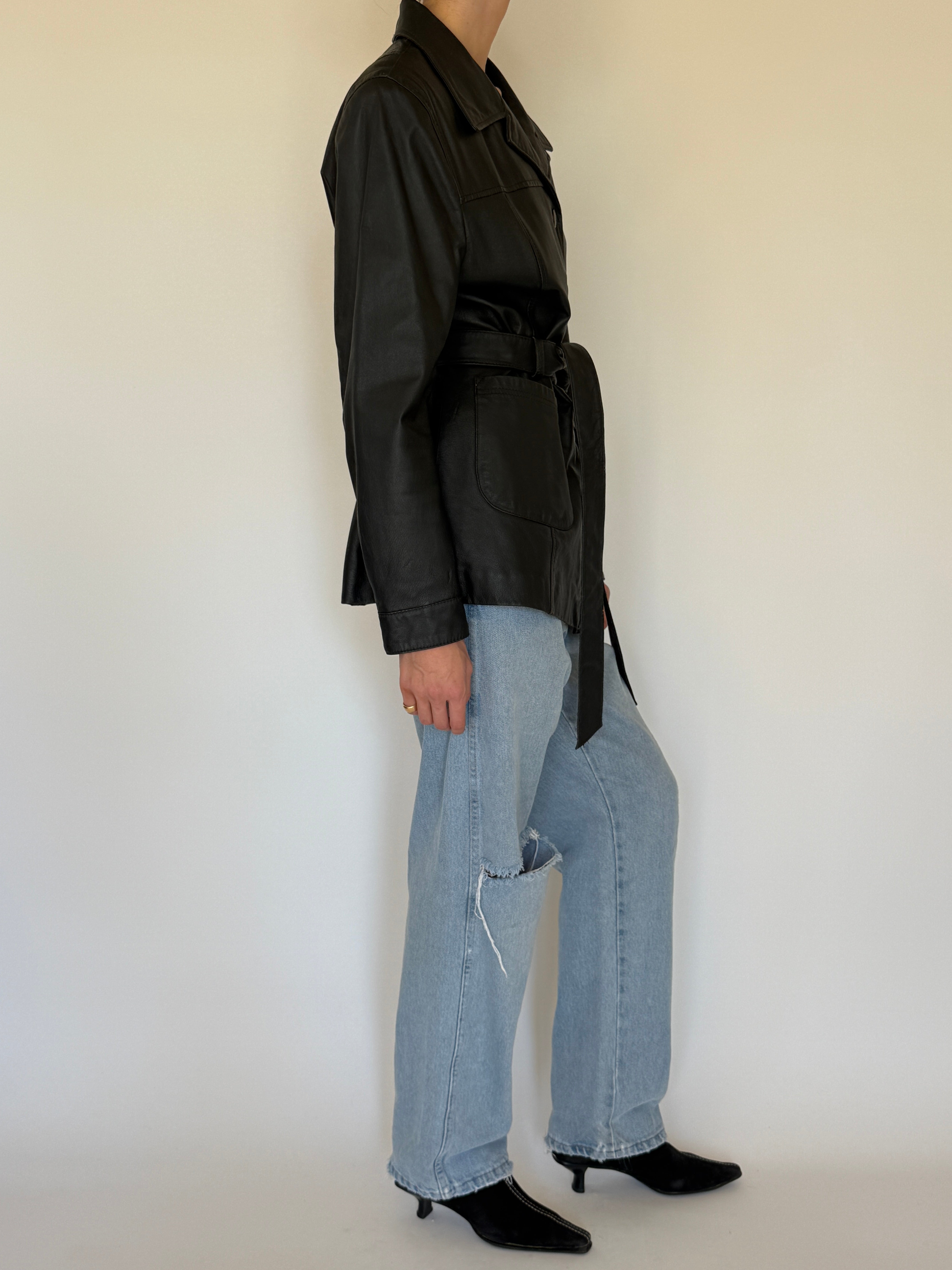 Vintage black leather jacket side view cinched waist
