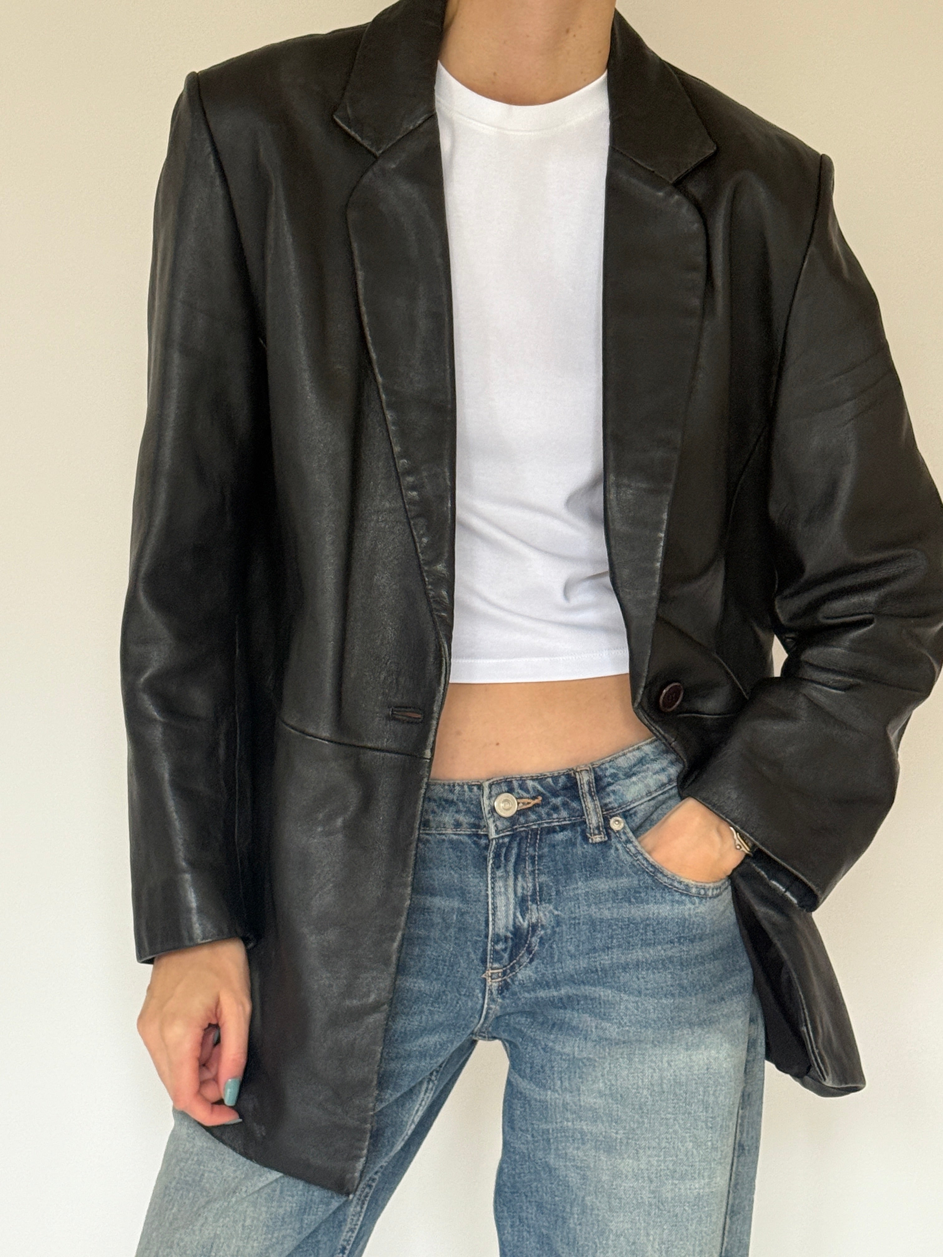 Vintage single-button detail on black leather blazer
