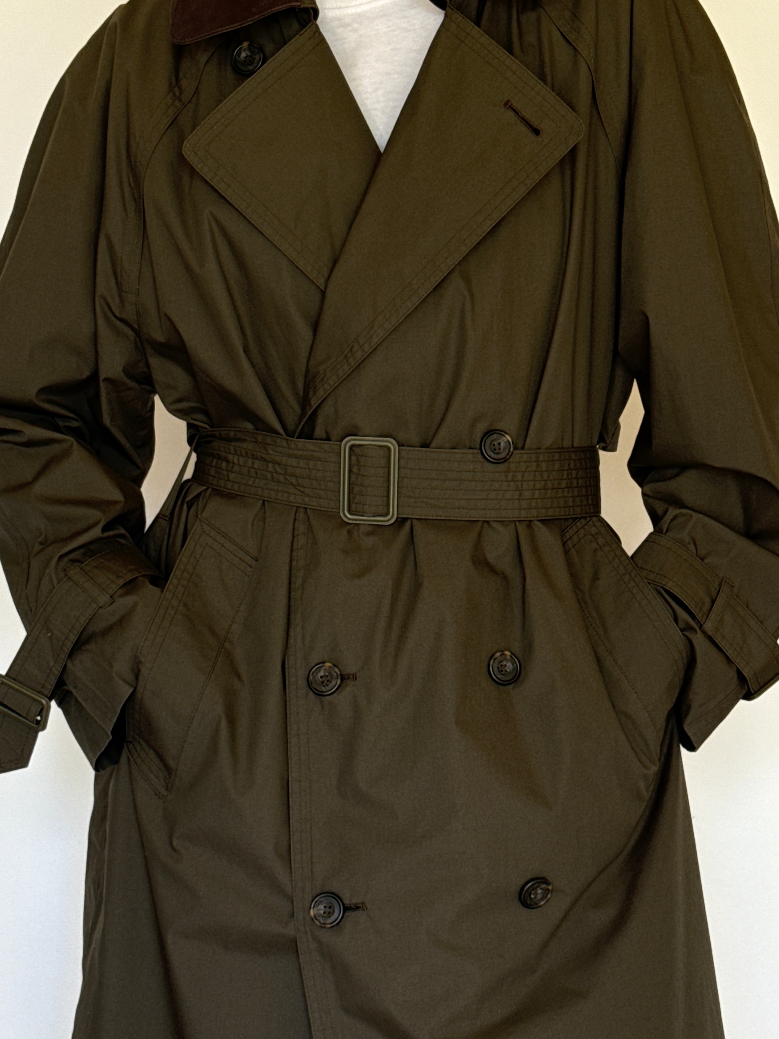 Vintage olive trench coat fabric close-up smooth texture